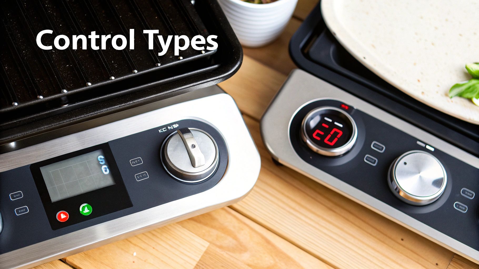 A close-up of a commercial griddle's control knobs, showing temperature settings.