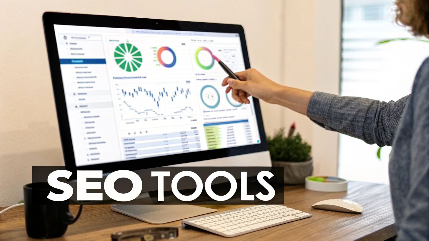 Person pointing at a computer screen showing SEO analytics, charts, and data, with 'SEO TOOLS' text.