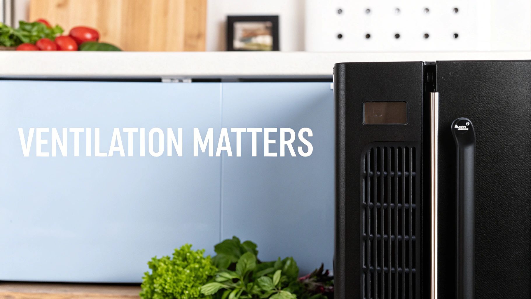 Under-counter fridge next to a blue cabinet with 'Ventilation Matters' text and fresh produce.