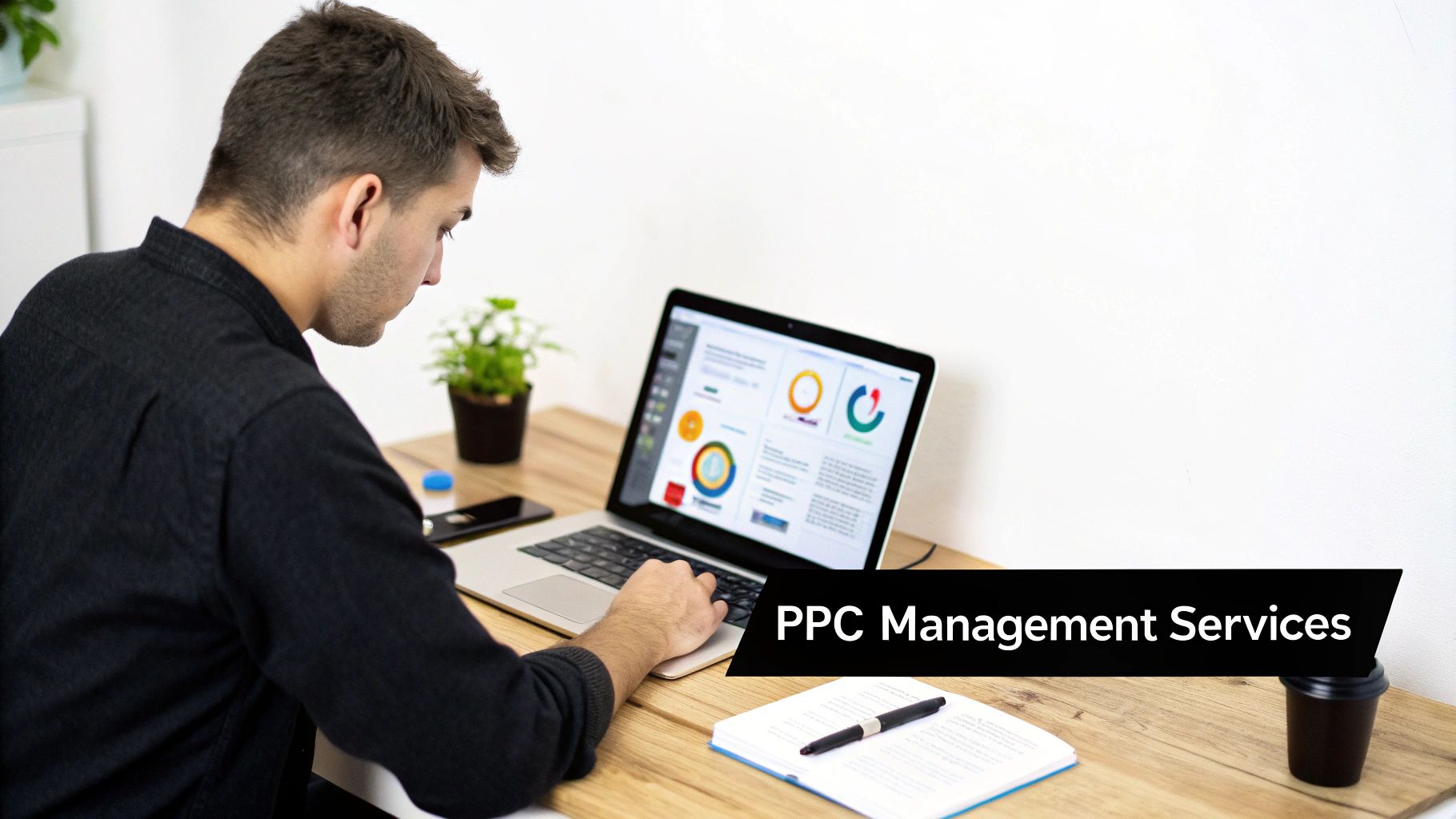 A man reviews performance charts on a laptop screen for PPC advertising management services.