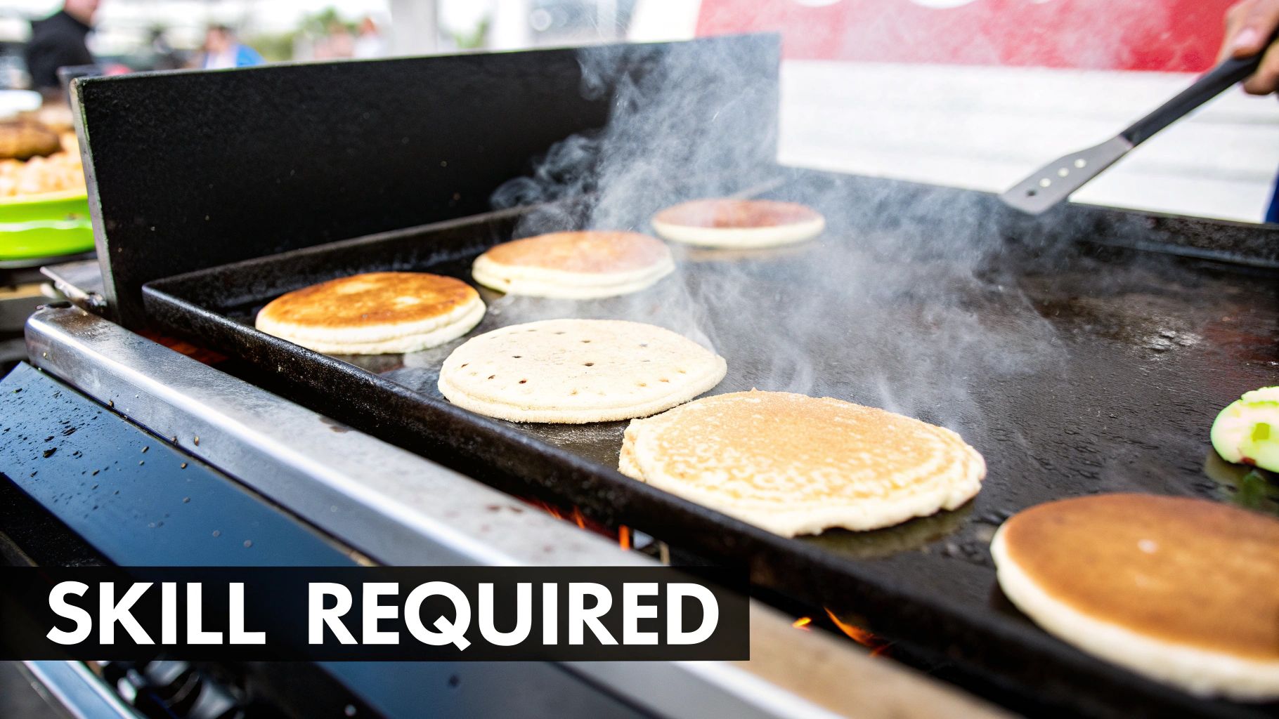 A chef expertly flipping burgers on a hot commercial griddle, showcasing temperature control in action.