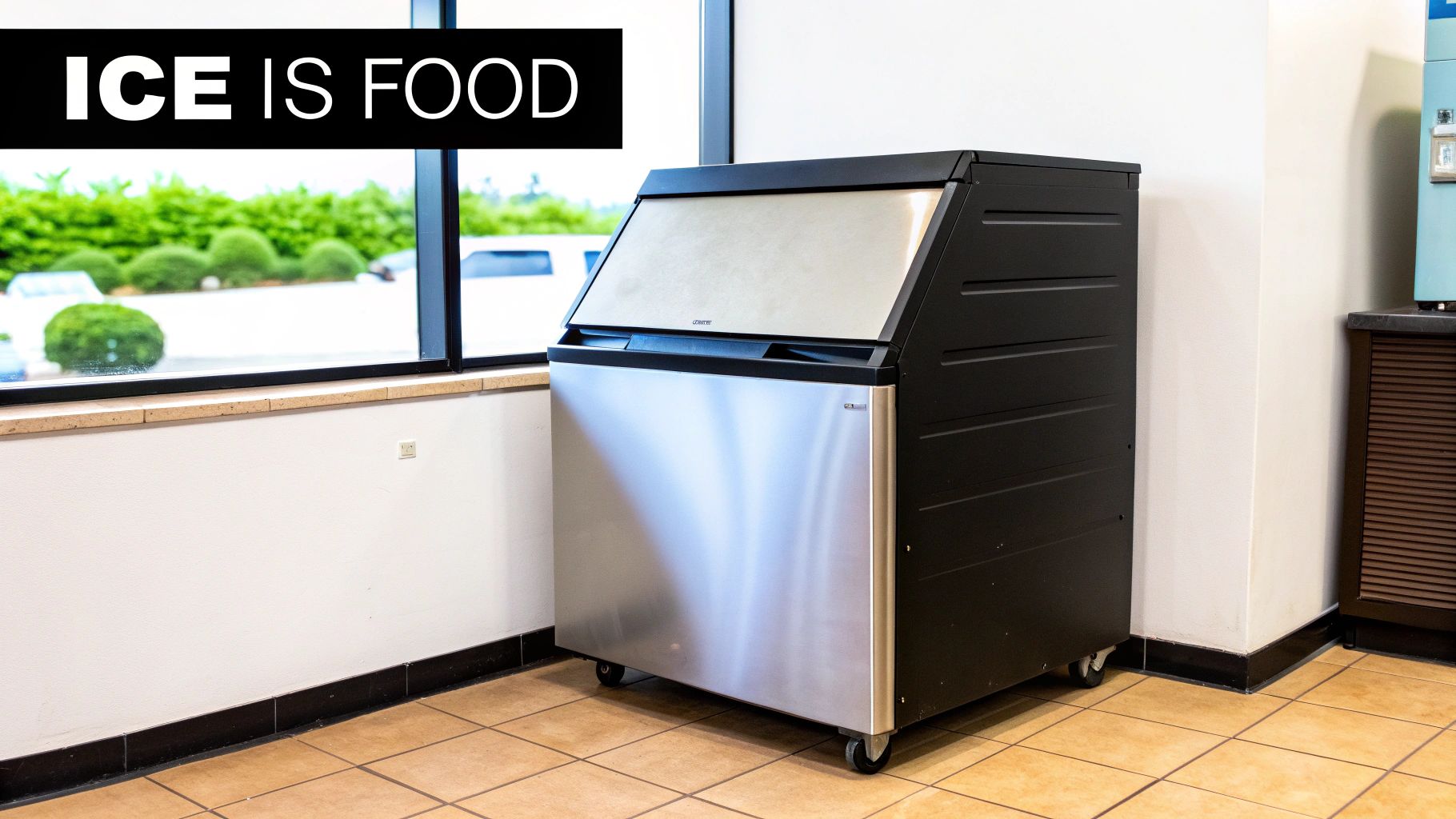 Commercial ice machine with stainless steel front and black body, in a room with a window. A banner reads "ICE IS FOOD".