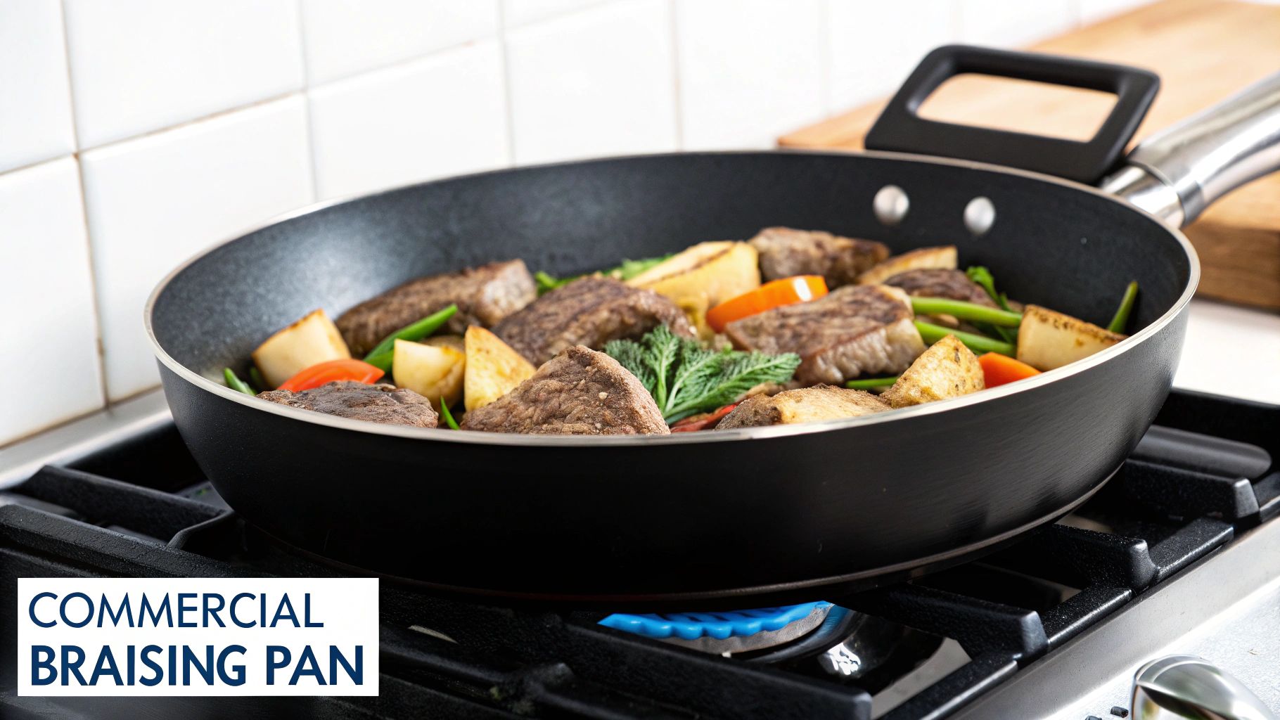 A commercial braising pan filled with seasoned meat and vegetables cooking on a gas stove with a blue flame.