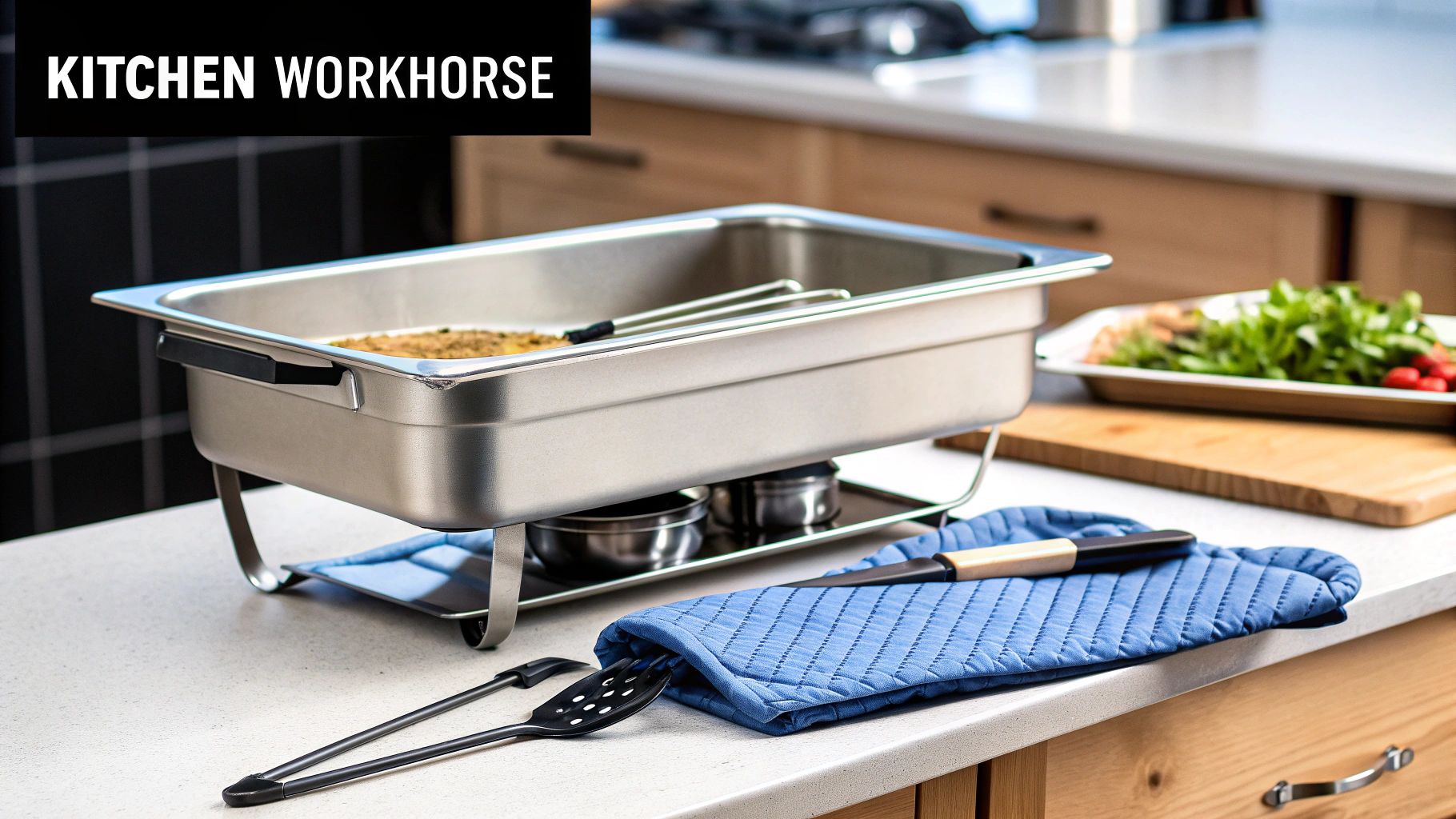 A stainless steel full-size steam table pan on a stand with tongs and a pot holder in a kitchen.