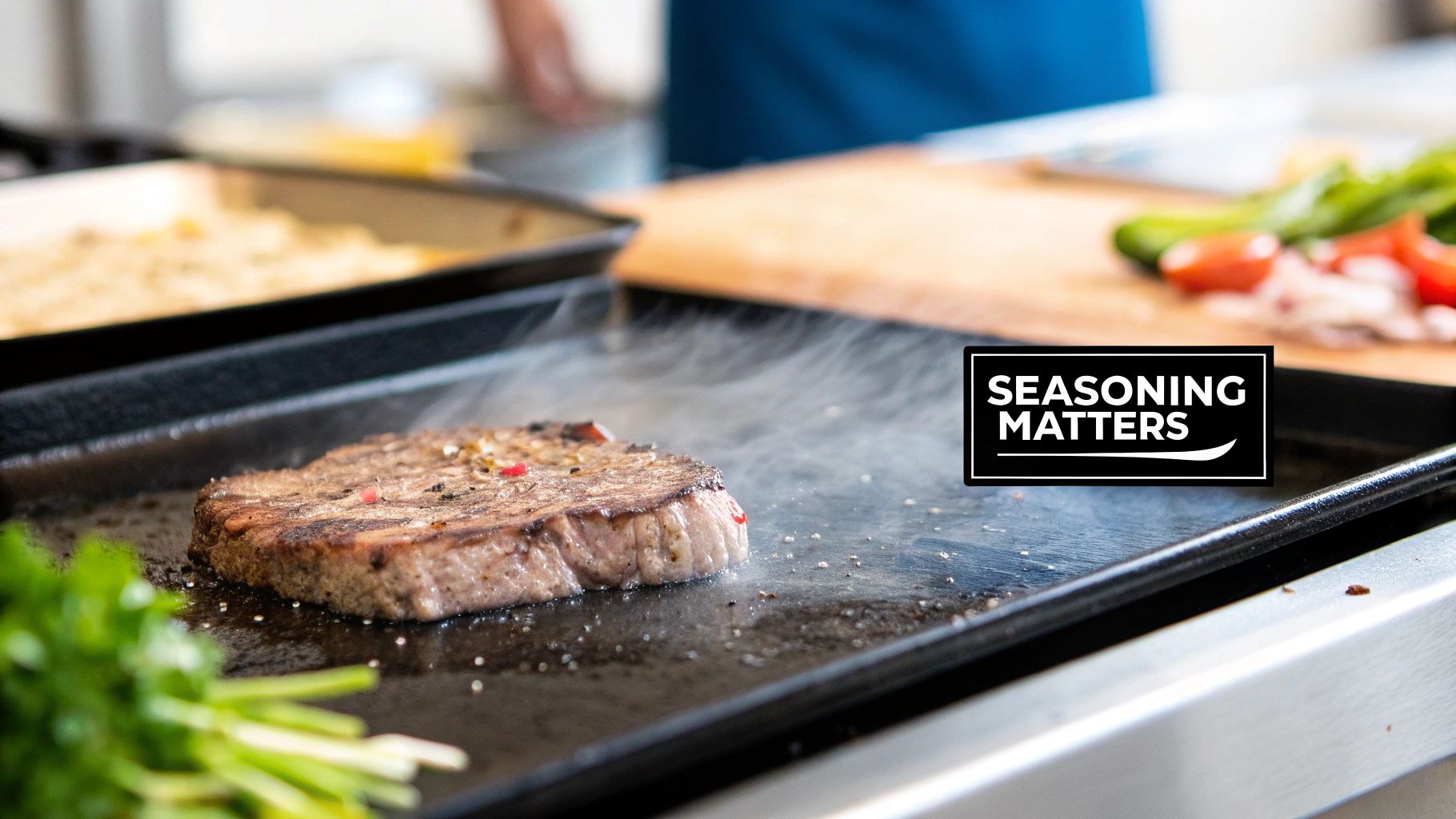 A seasoned steak cooking on a hot griddle with visible steam, vegetables, and text 'SEASONING MATTERS'.