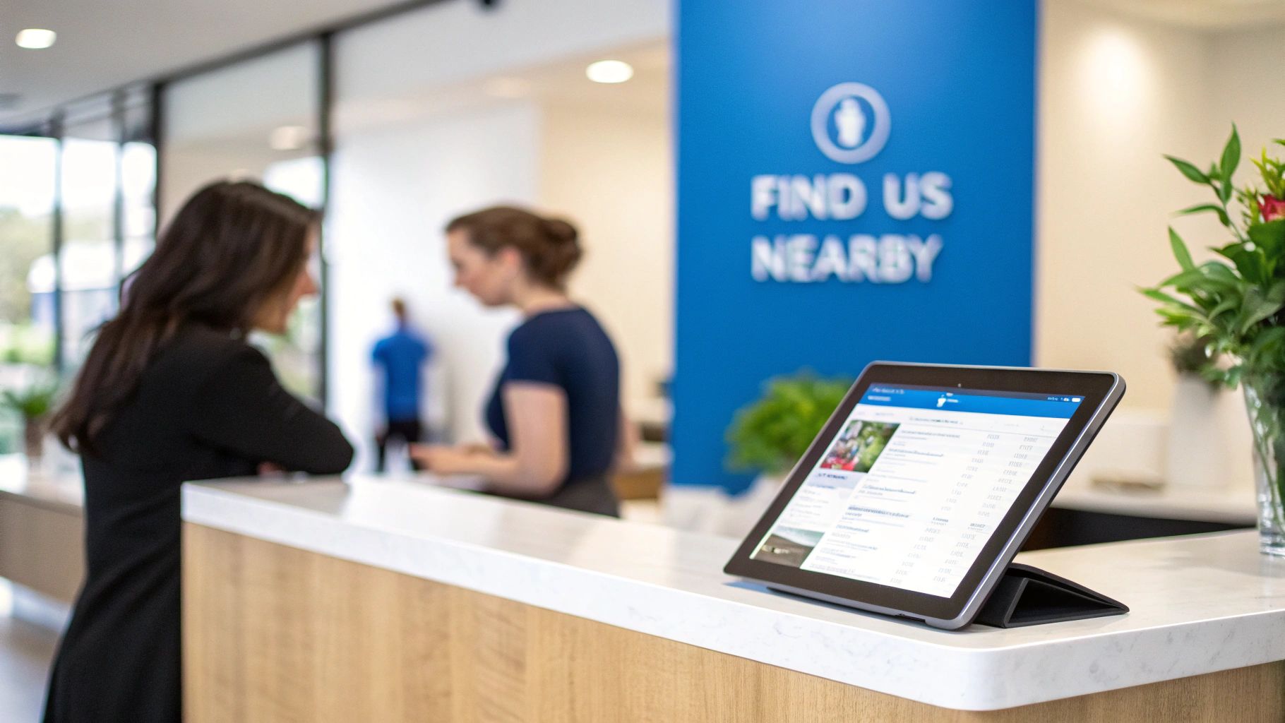 A dentist reviewing a patient's chart on a tablet, with a bright and modern office in the background.