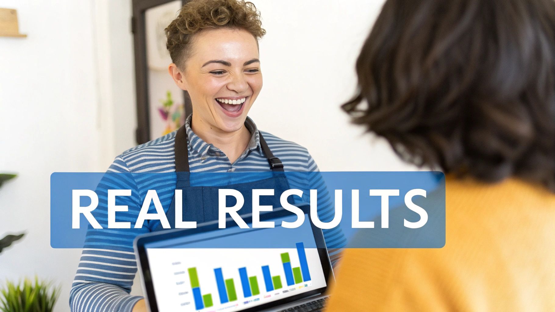 Smiling person in an apron showing real results with bar charts on a laptop screen to another.