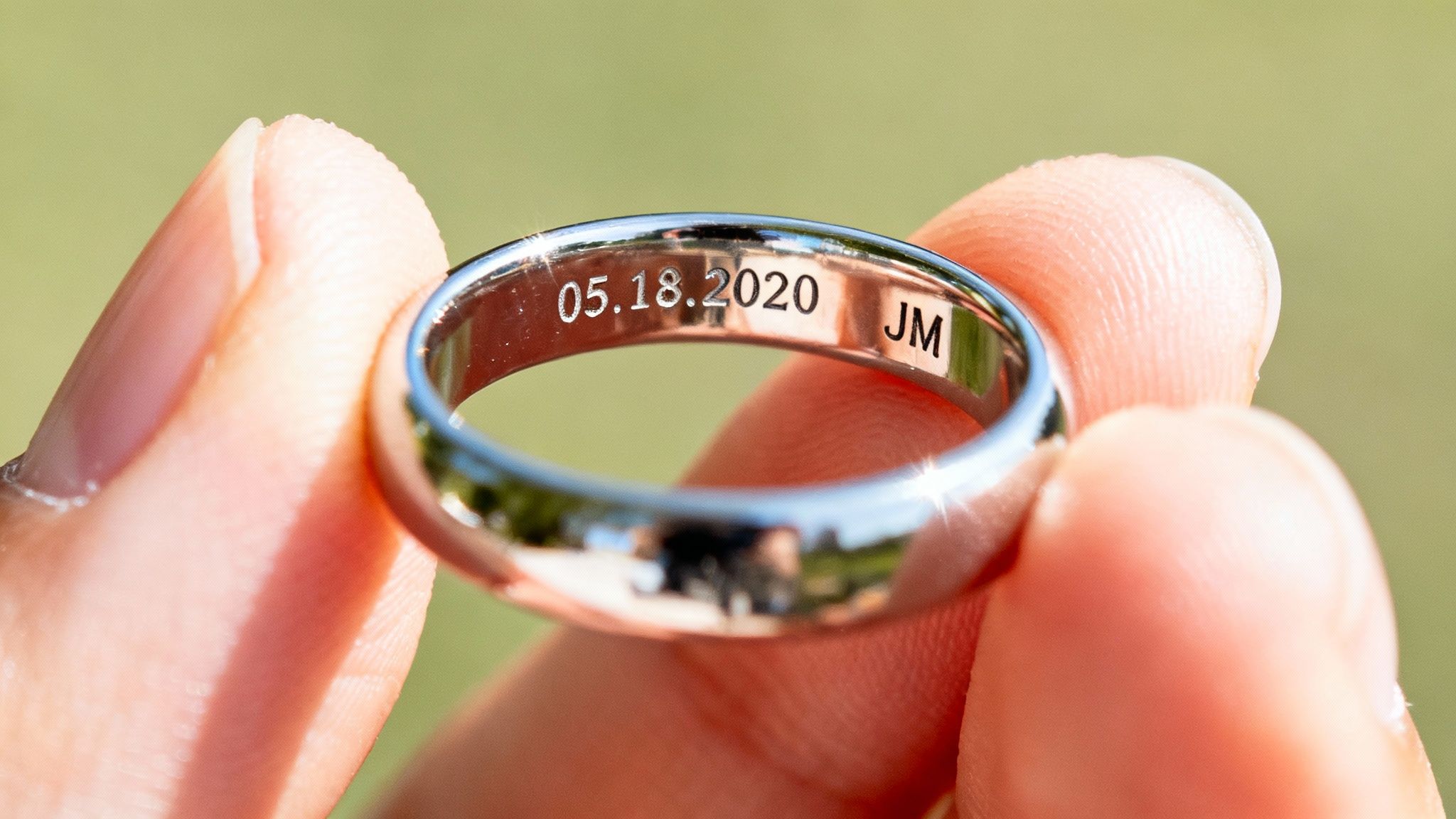 A close-up of a jeweler engraving a custom design onto a gold ring.