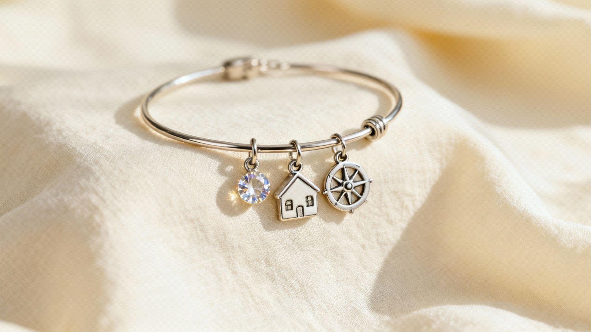 A close-up of a birthday charm bracelet with intricate charms on a white background.