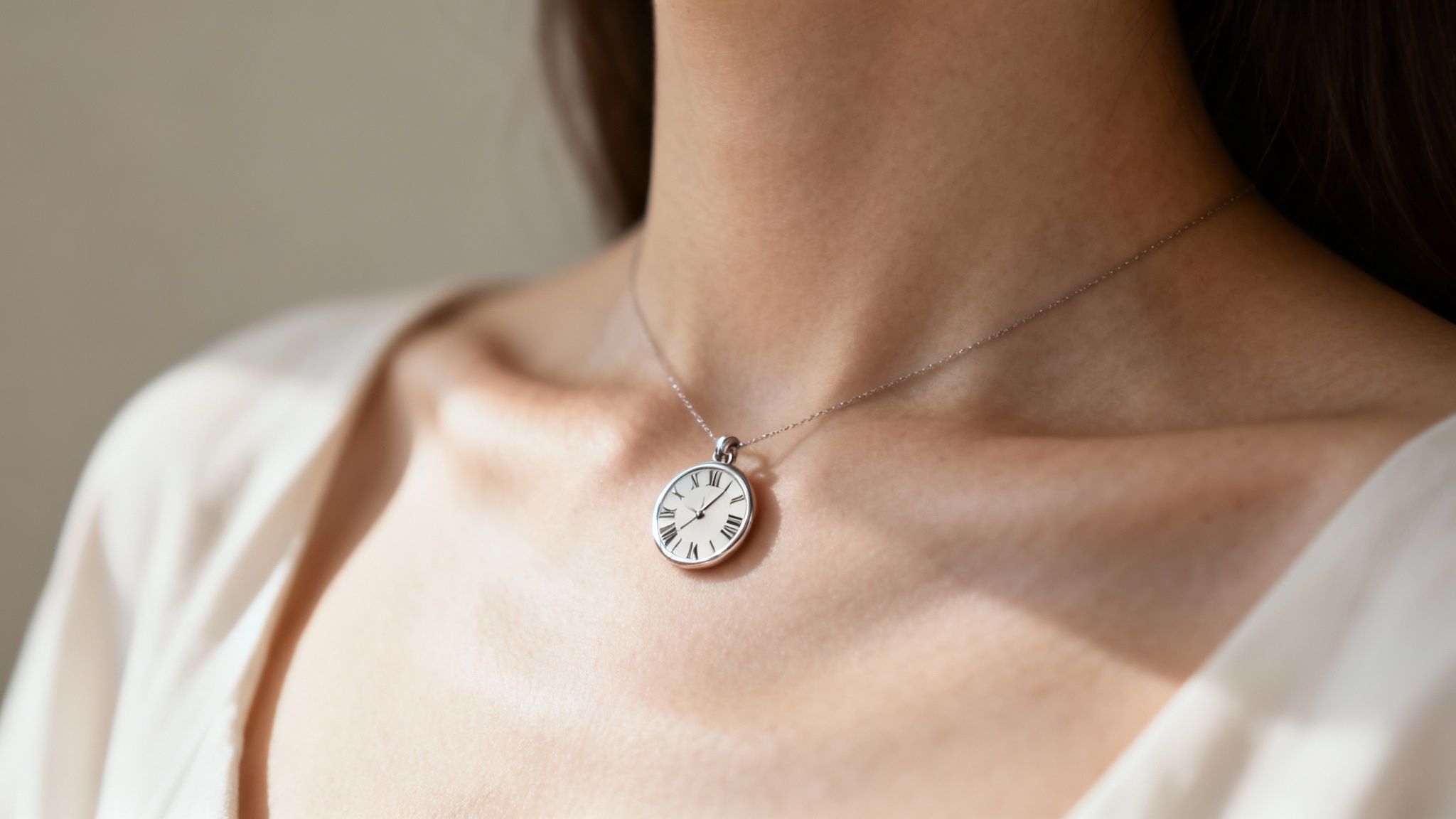 A close-up of a woman wearing a gold bar roman numeral necklace, with the focus on the elegant engraving.