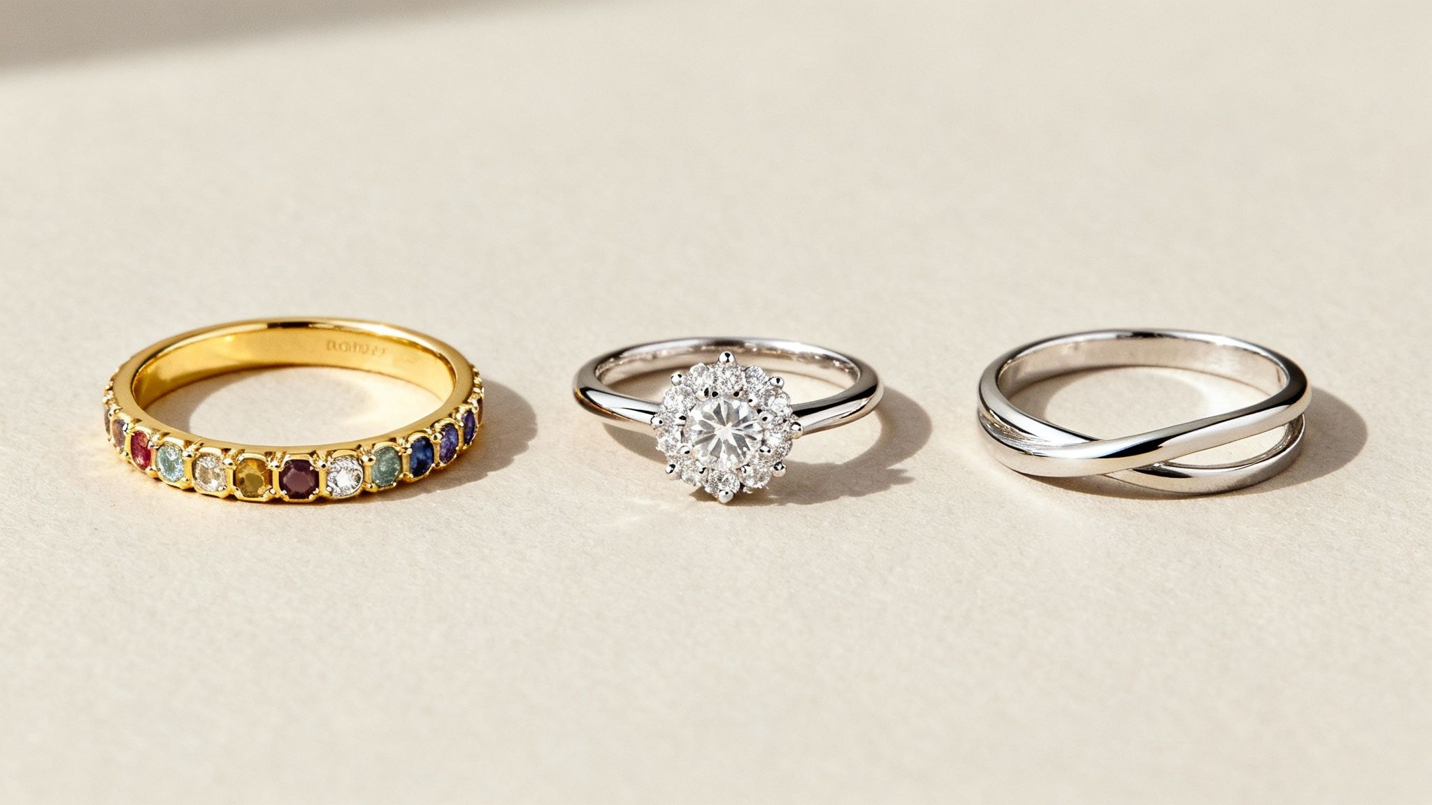 A classic mother's ring with three birthstones set in a row on a yellow gold band.