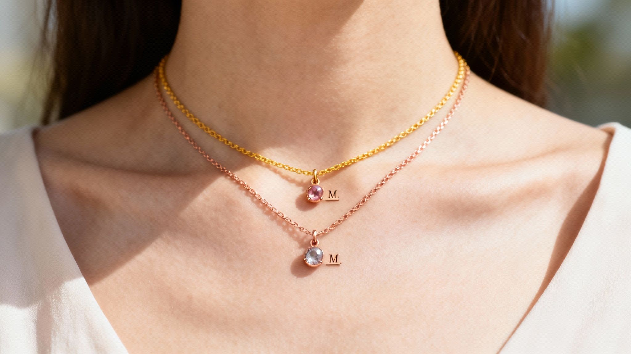 A close-up of a delicate mother daughter birthstone necklace with customized charms.