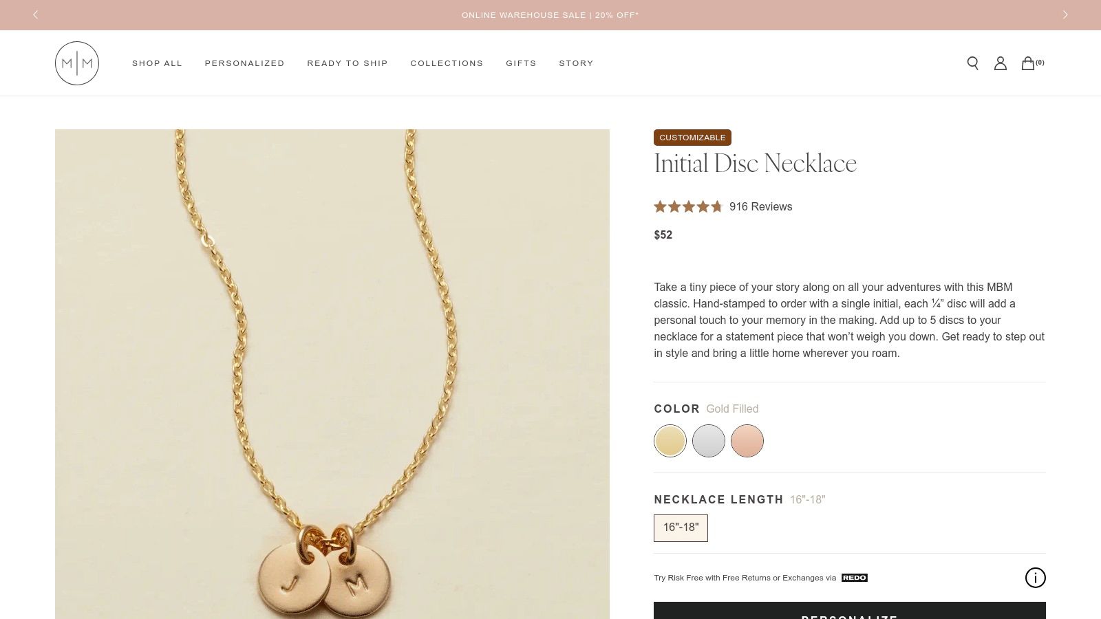 Made by Mary initial disk necklace on a neutral background