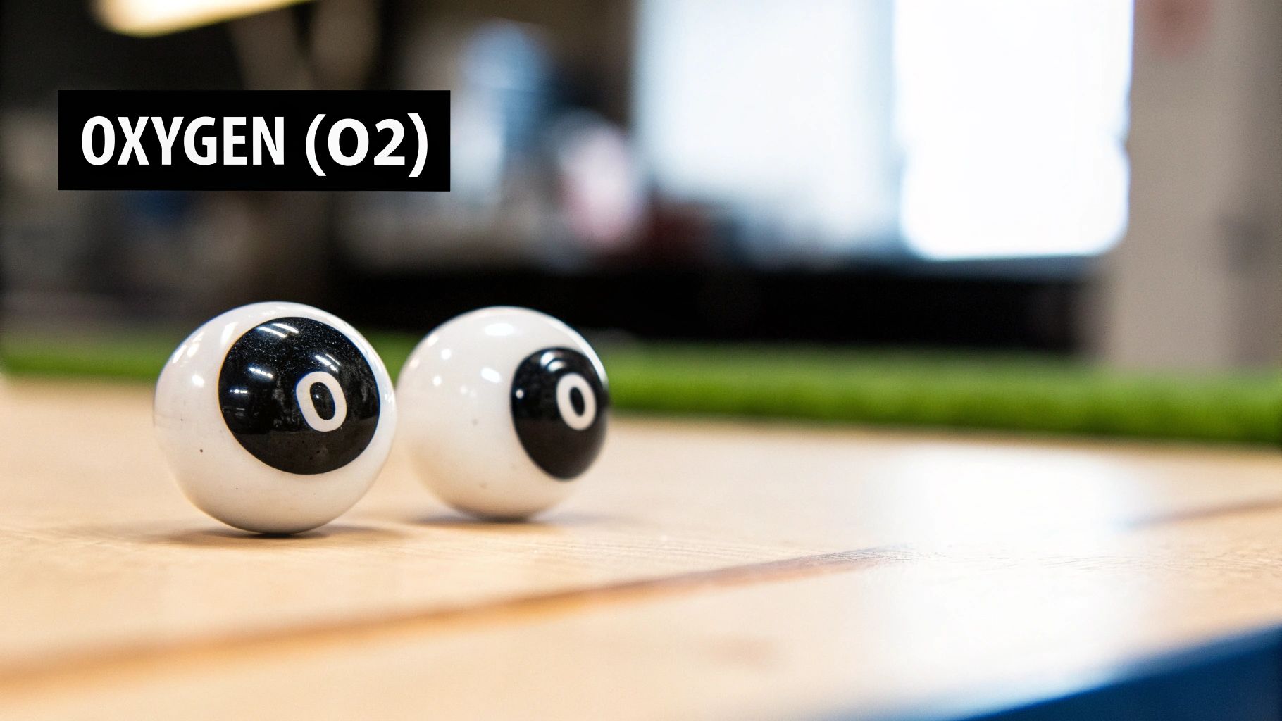 Two white billiard-like balls marked with 'O' and text 'OXYGEN (O2)', symbolizing an oxygen molecule.