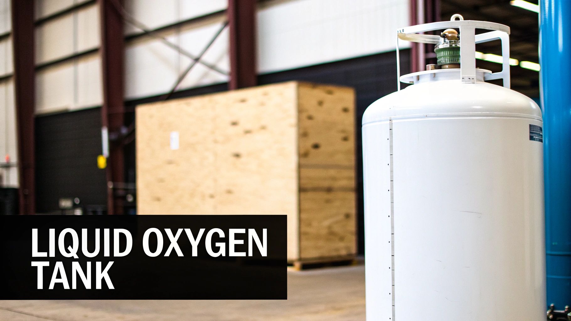 A white liquid oxygen tank stands prominently in a warehouse, with a large wooden crate behind it.