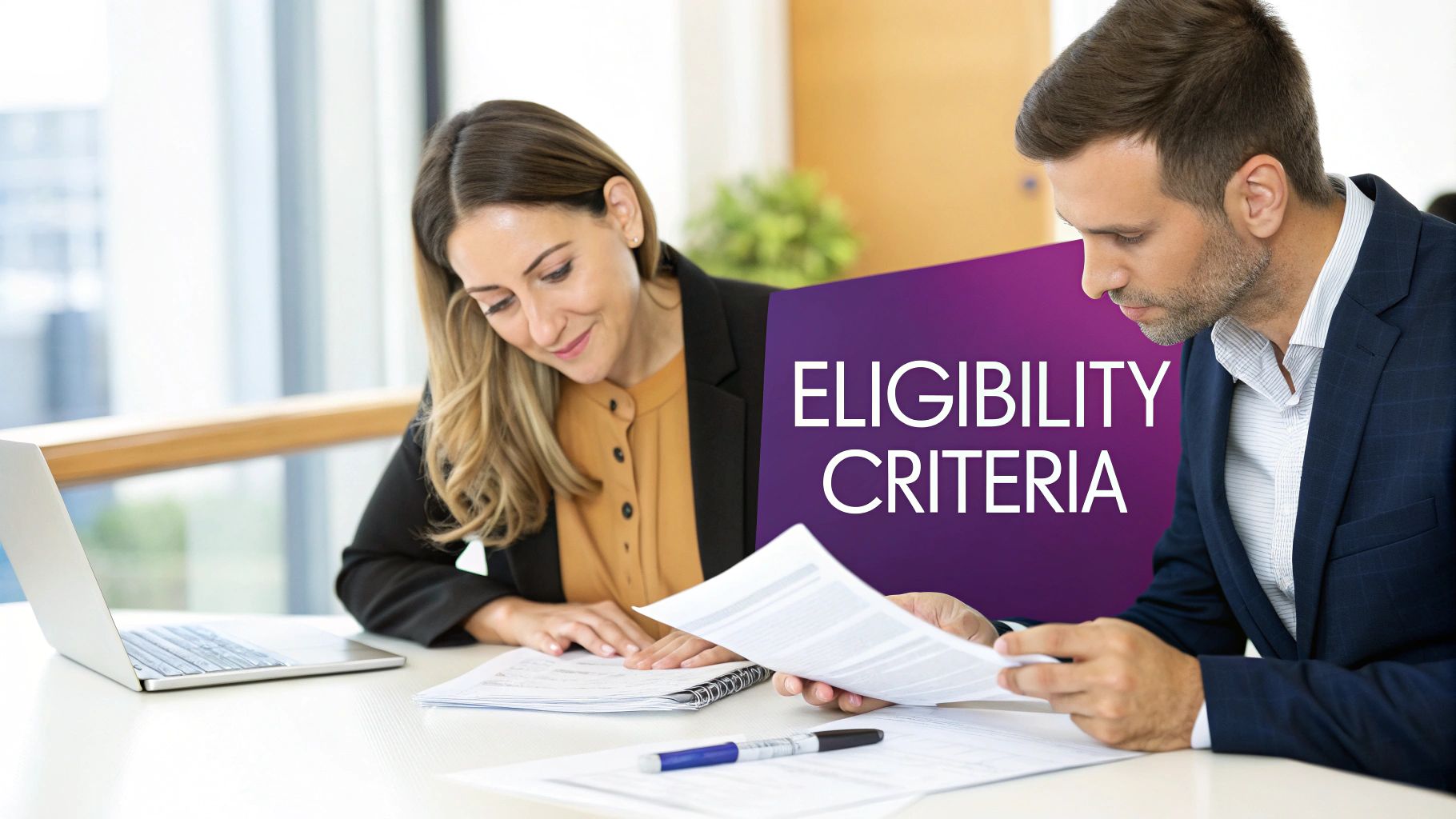 Couple looking at a laptop, planning their move to the UAE.