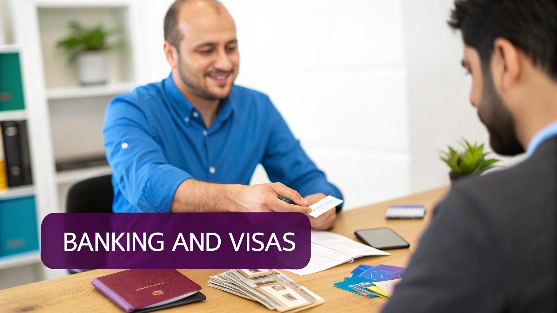 Two men discussing banking and visas at an office desk with documents and passports.