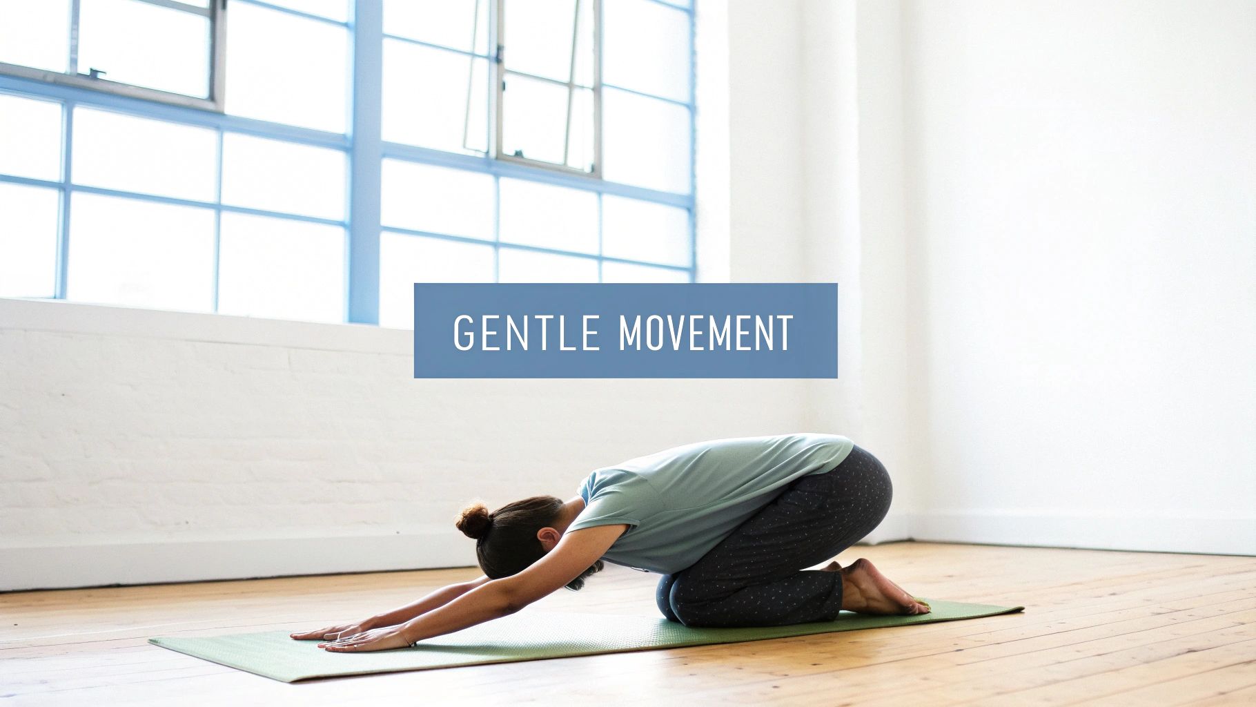 A person in Child's Pose on a green yoga mat, with text overlay "GENTLE MOVEMENT" in a bright room.