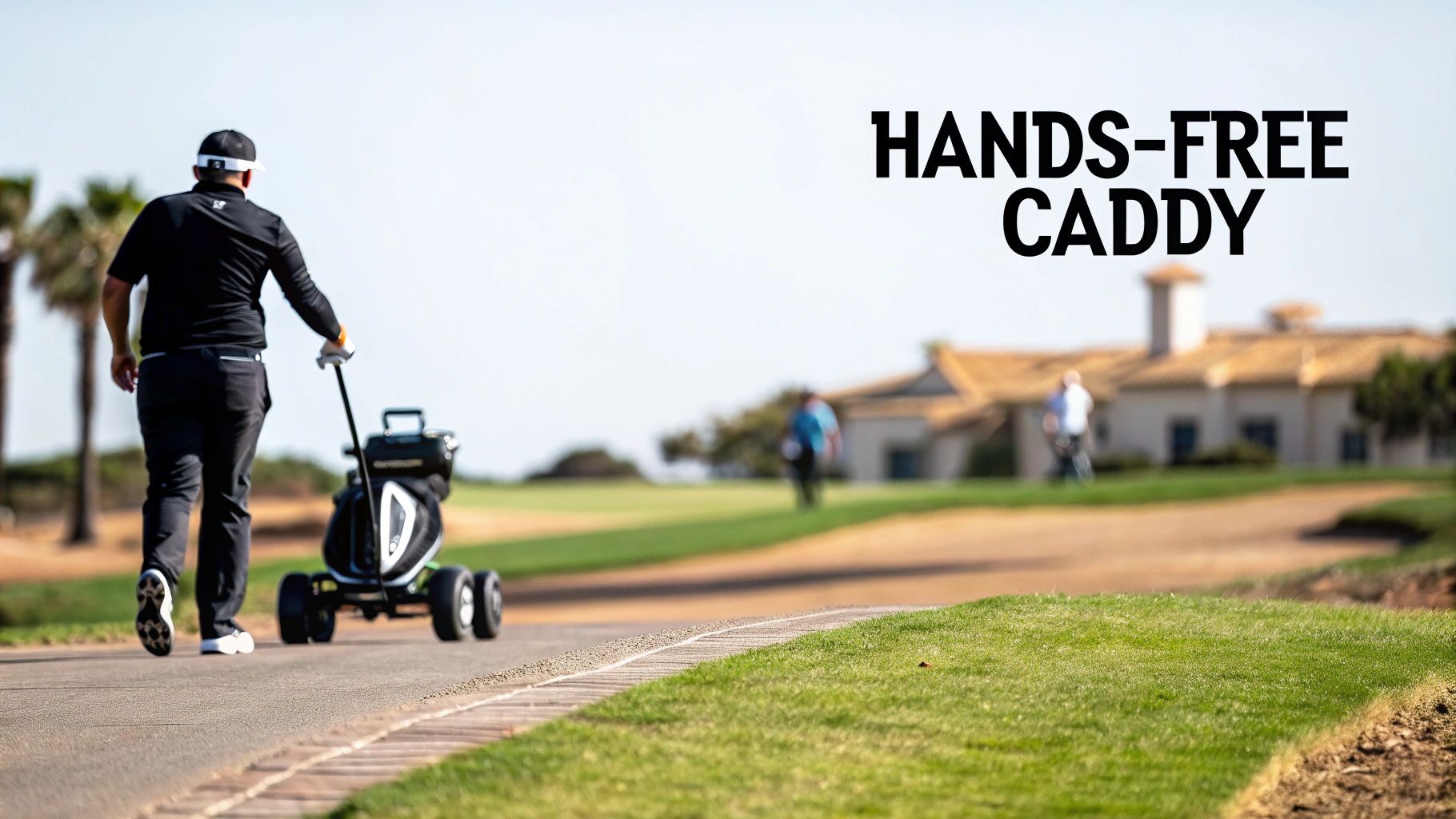 A golfer walks on a paved path, pushing a sleek black electric golf cart on a sunny day.