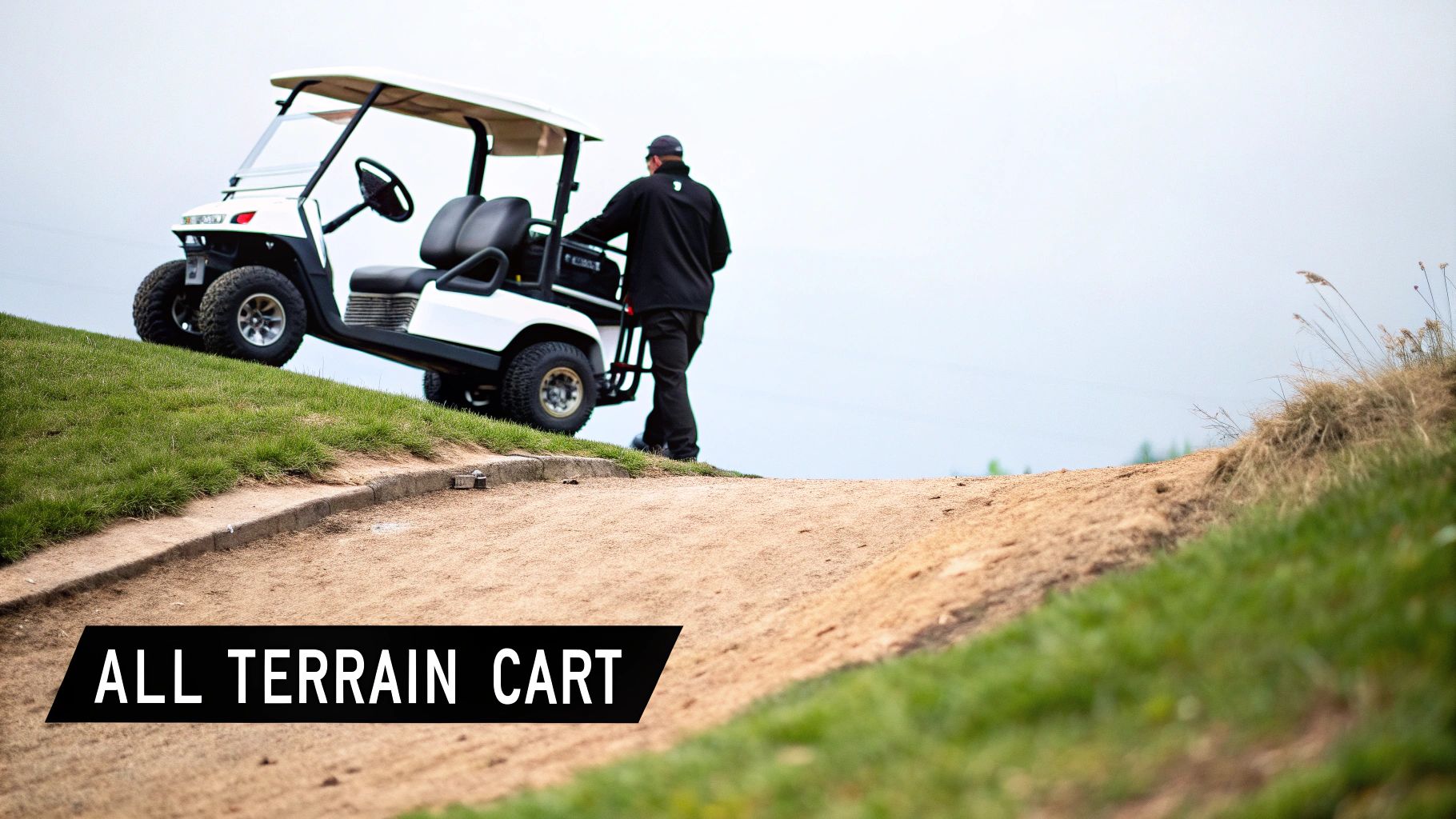A white all-terrain cart with a person drives uphill on a dirt path on a golf course.