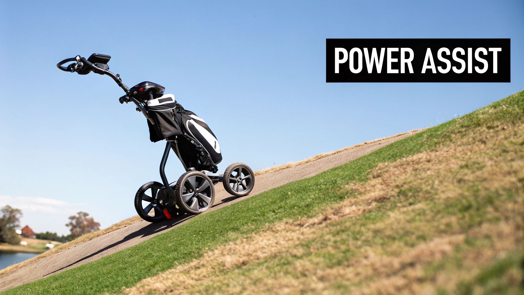 A black power-assist golf push cart with a golf bag climbs a sunny, grassy hill on a golf course.