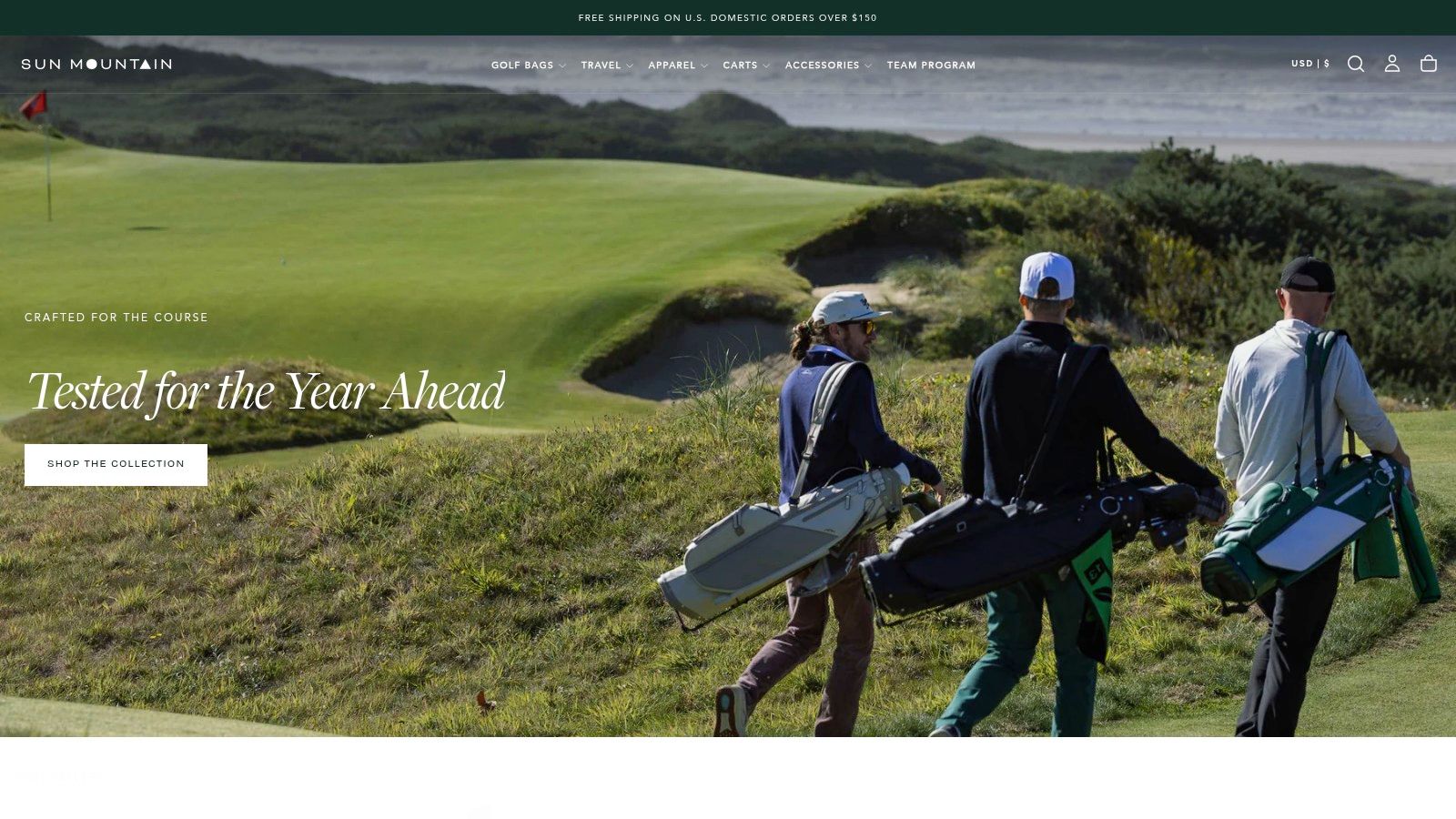 A golfer walks the course with a Sun Mountain push cart on a sunny day