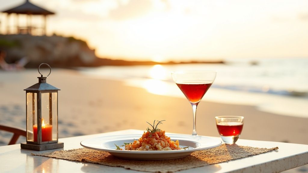 A beautifully set table on a beach with a meal, red drinks, and a glowing lantern at sunset.