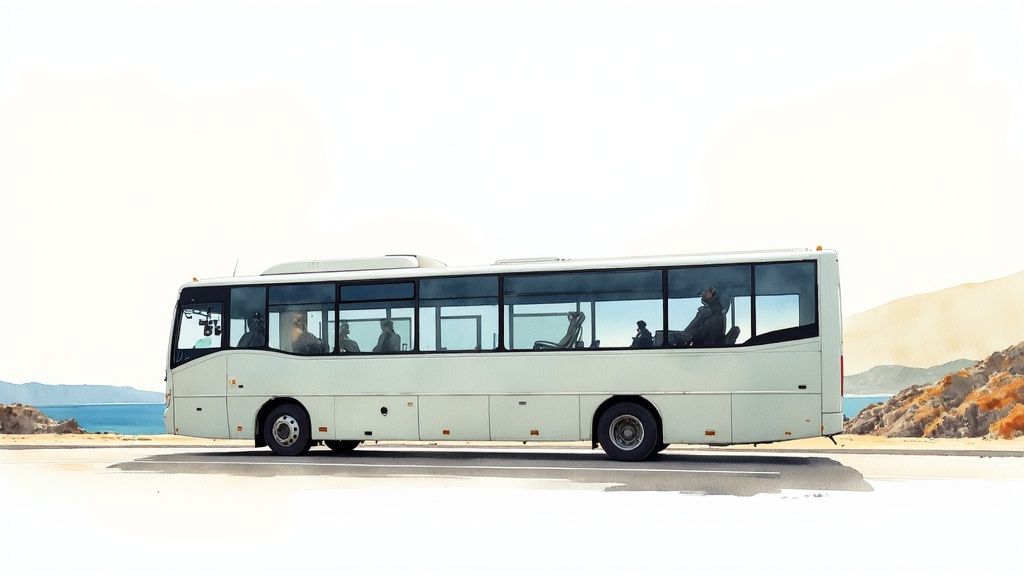 A white bus with passengers drives along a scenic coastal road next to the ocean.