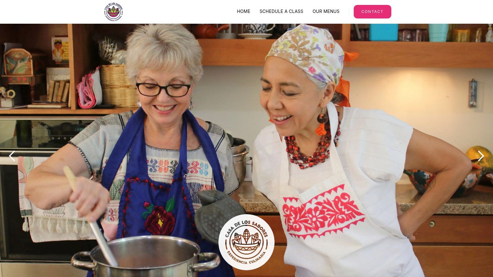 Participants engaged in a hands-on cooking class at Casa de los Sabores, learning from Chef Pilar Cabrera in her colourful home kitchen.