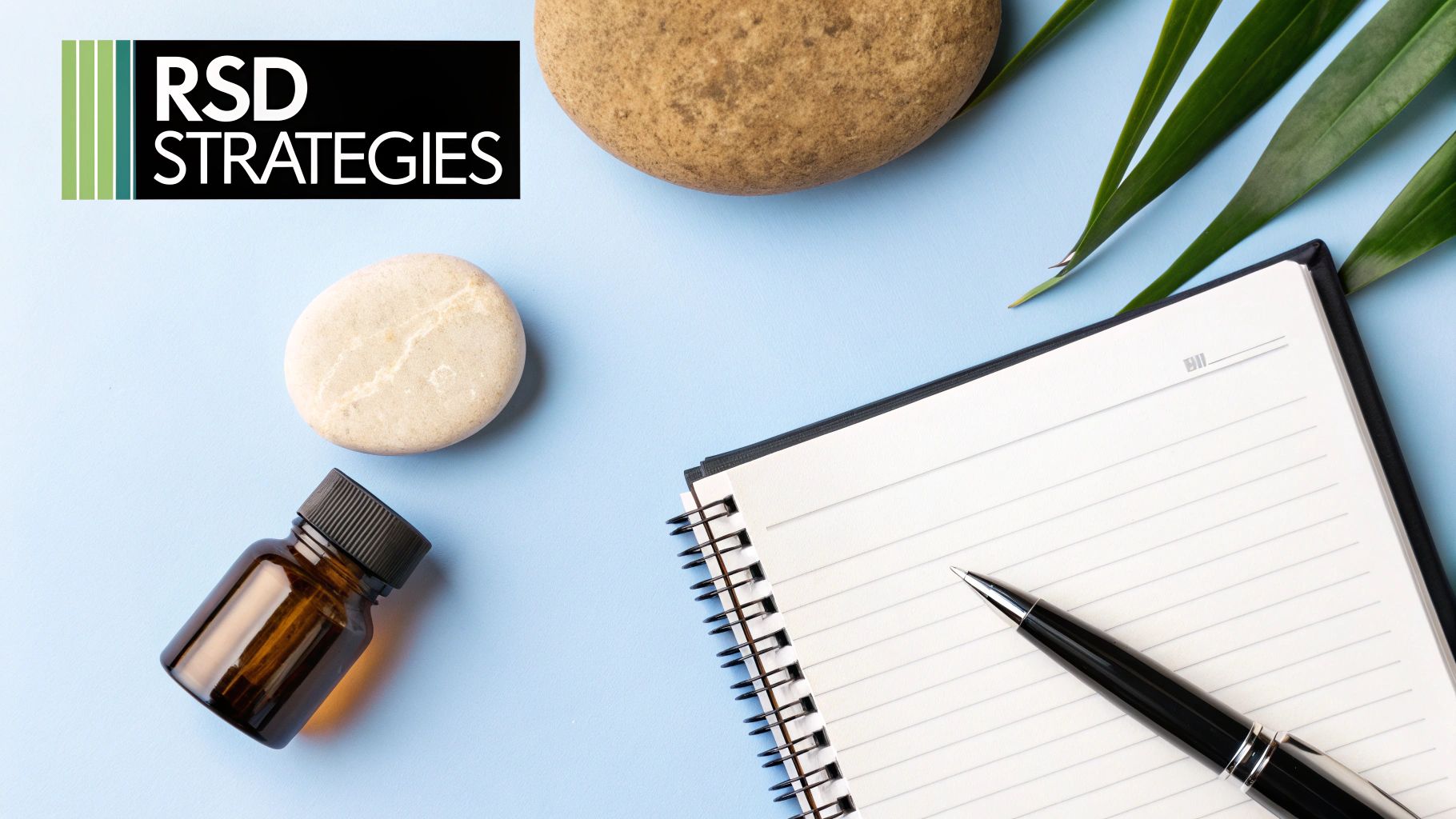 A flat lay image showing an RSD STRATEGIES logo, stones, a bottle, a notebook, and a pen on a blue background.