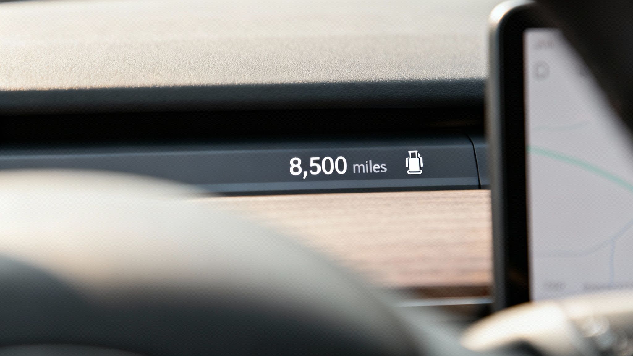 A technician pouring fresh motor oil into a car's engine.