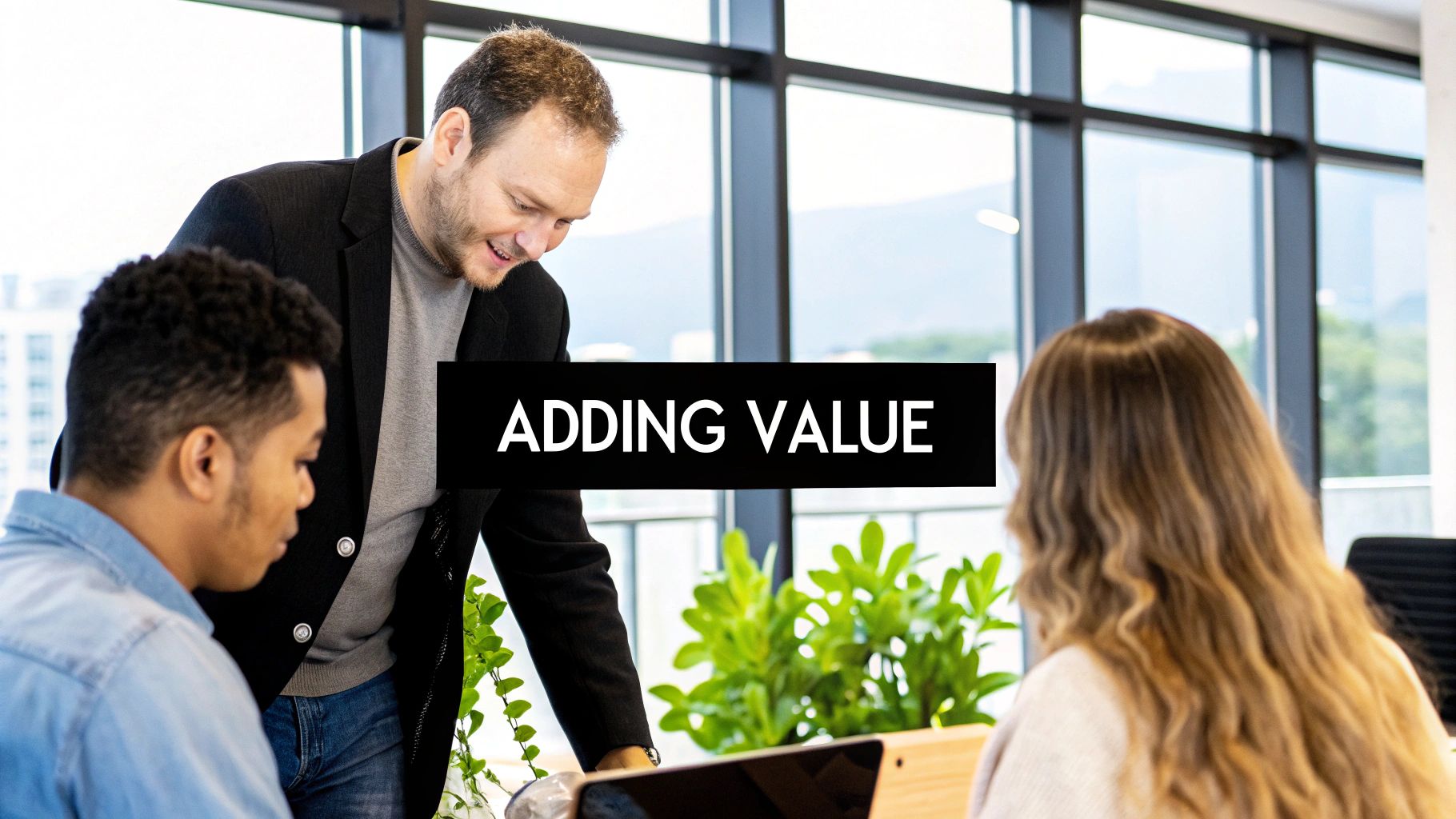 Two people collaborating over a laptop with charts and graphs