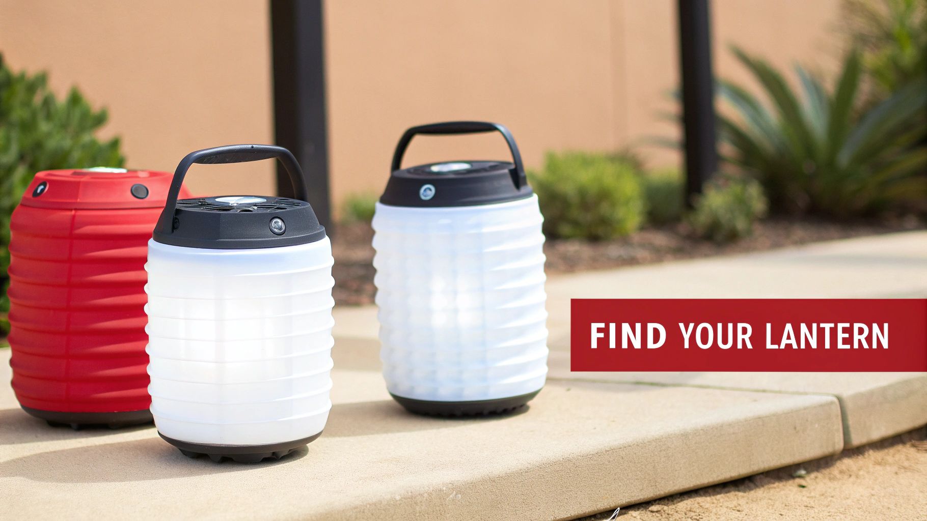 Three portable lanterns, two white and illuminated, one red, sitting on a concrete path outdoors.