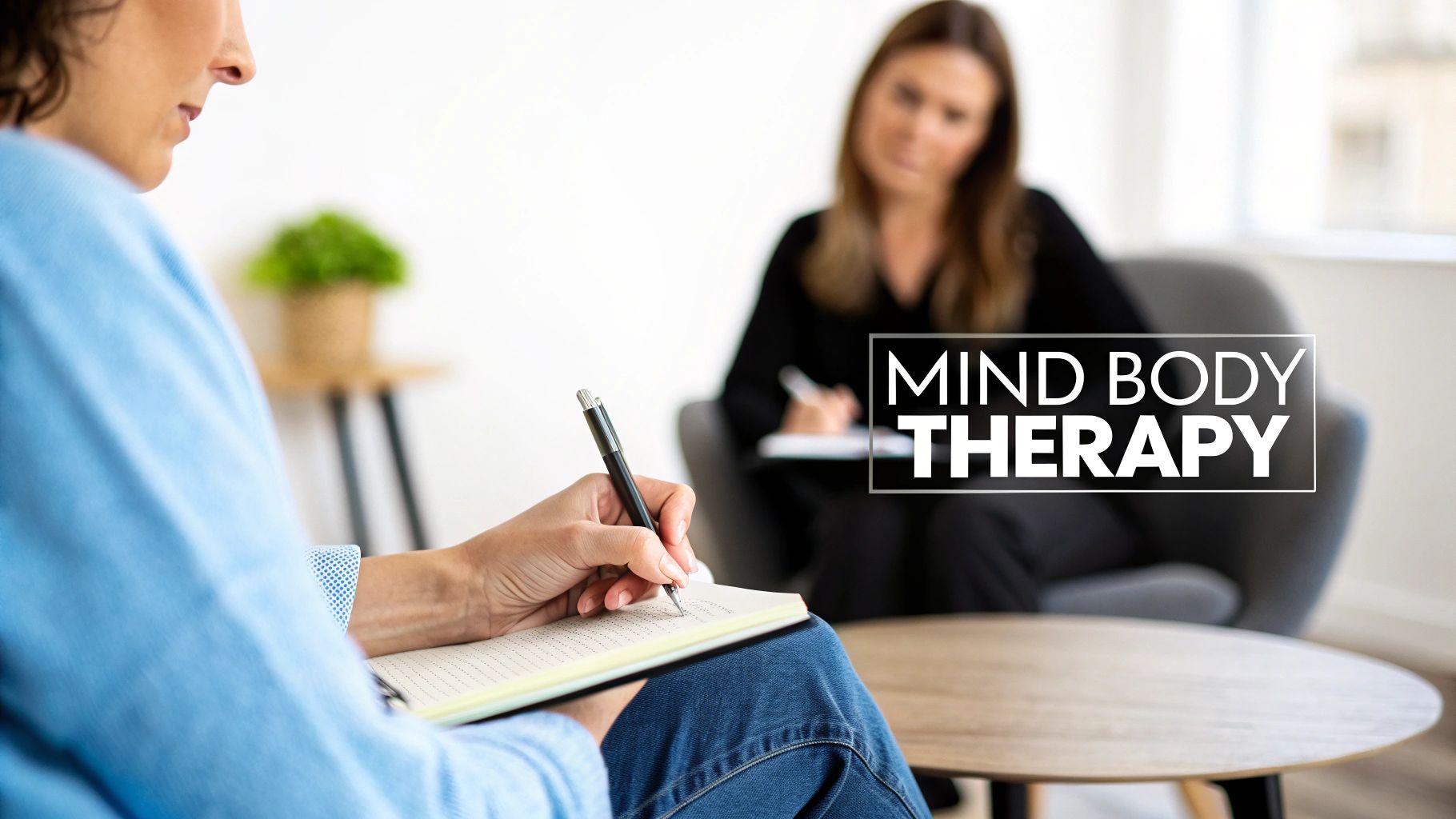 A client writes during a mind-body therapy session with a female therapist.