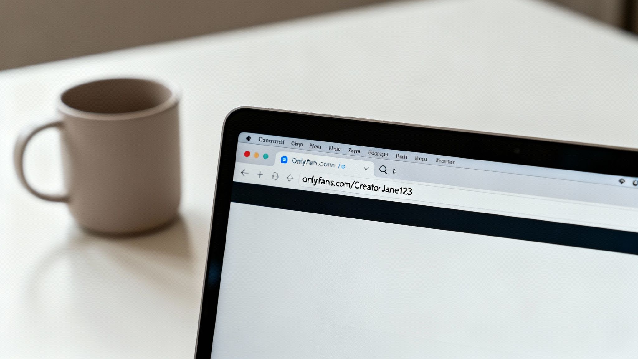 A close-up of a laptop screen showing the OnlyFans website with a creator's profile URL.