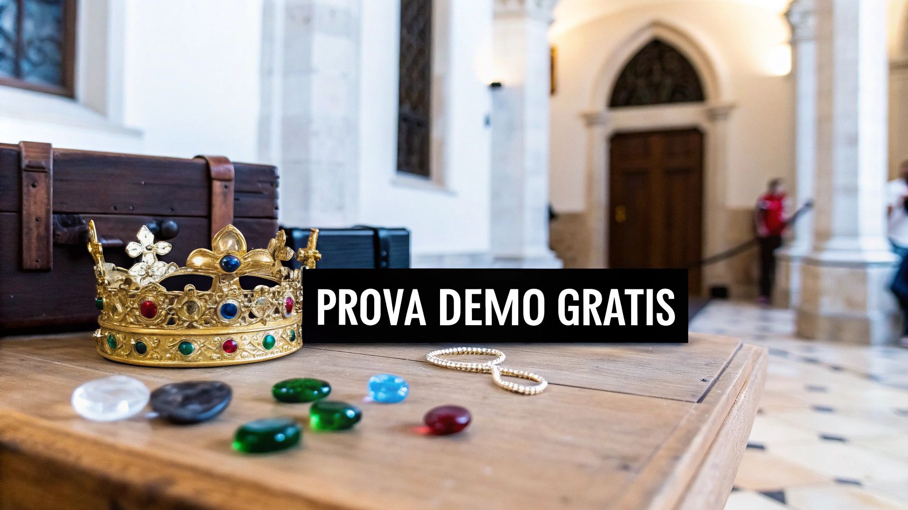 Una corona d'oro con gioielli e un forziere su un tavolo, con la scritta "PROVA DEMO GRATIS".