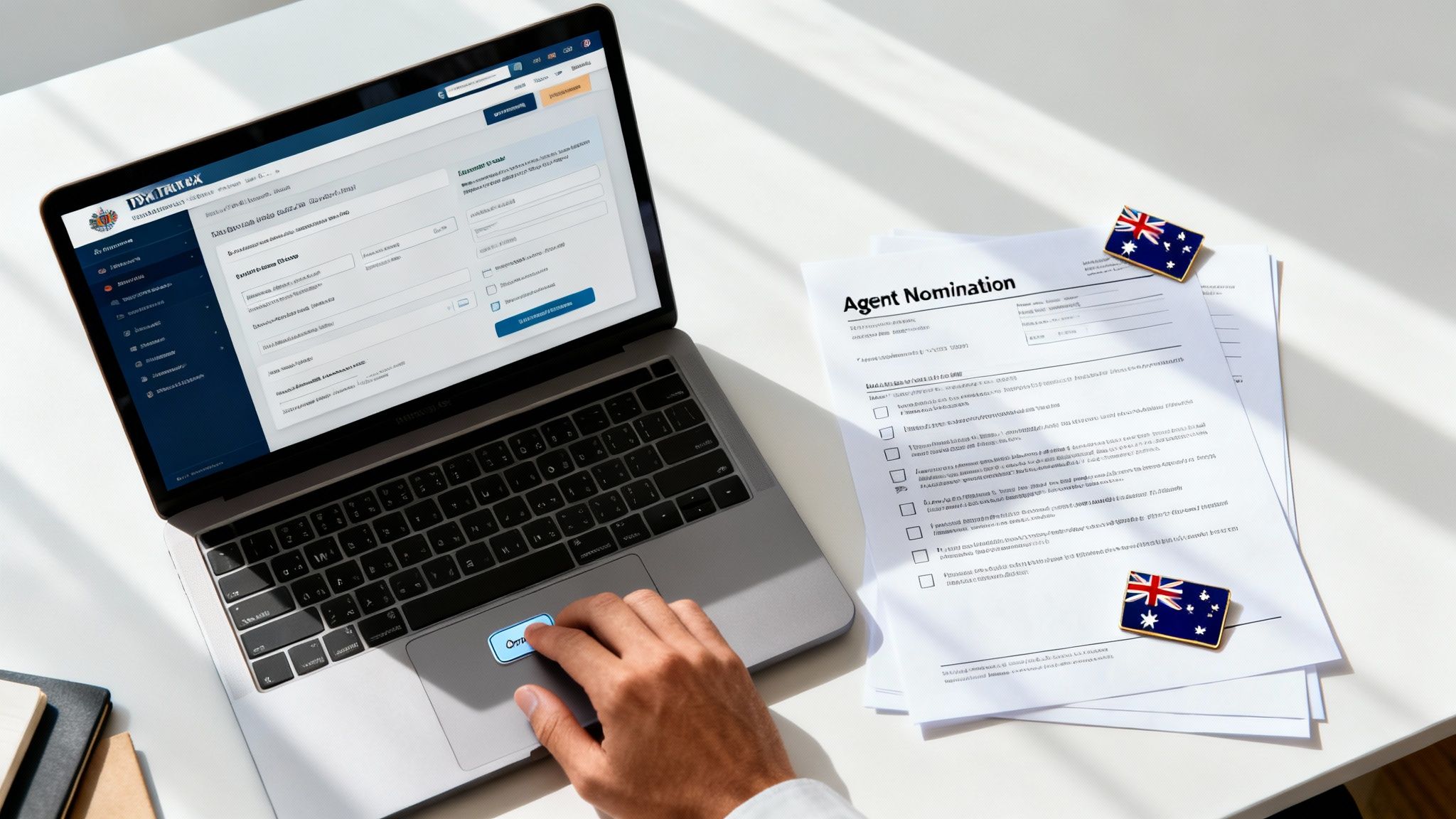 호주 ATO 에이전트 노미네이션 절차를 보여주는 노트북 화면과 문서가 놓인 작업 공간 이미지