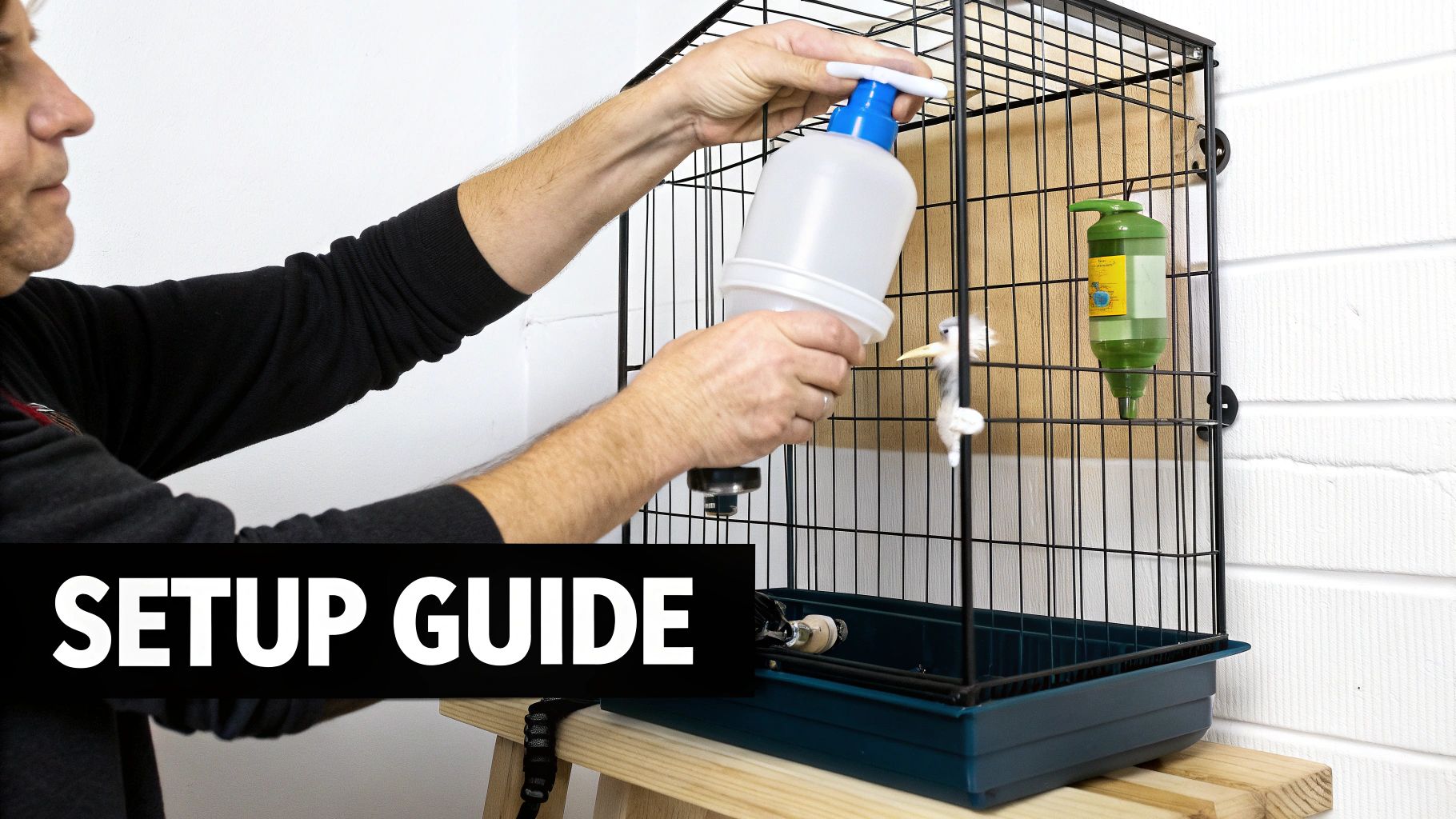 Hands installing a large white water feeder into a black bird cage during setup.