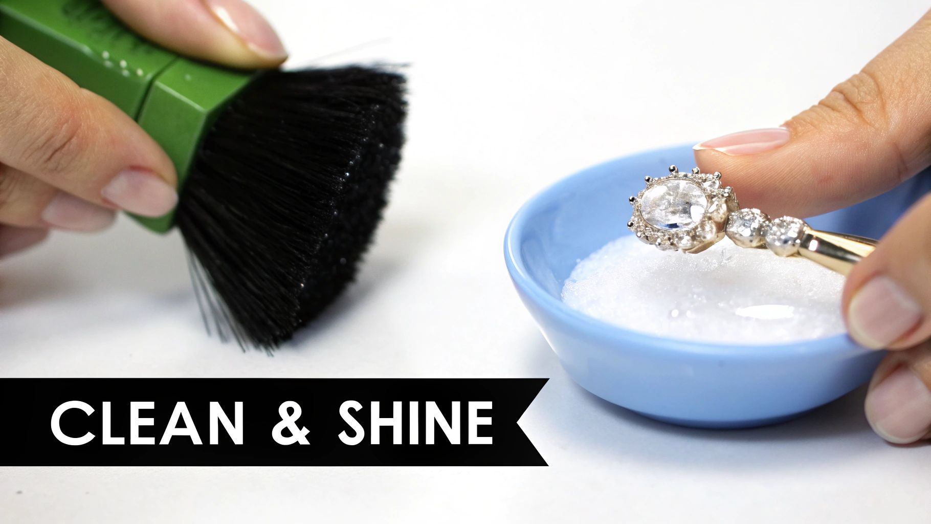 Hands cleaning a sparkling diamond-like jewelry piece with a brush and white powder in a blue bowl.