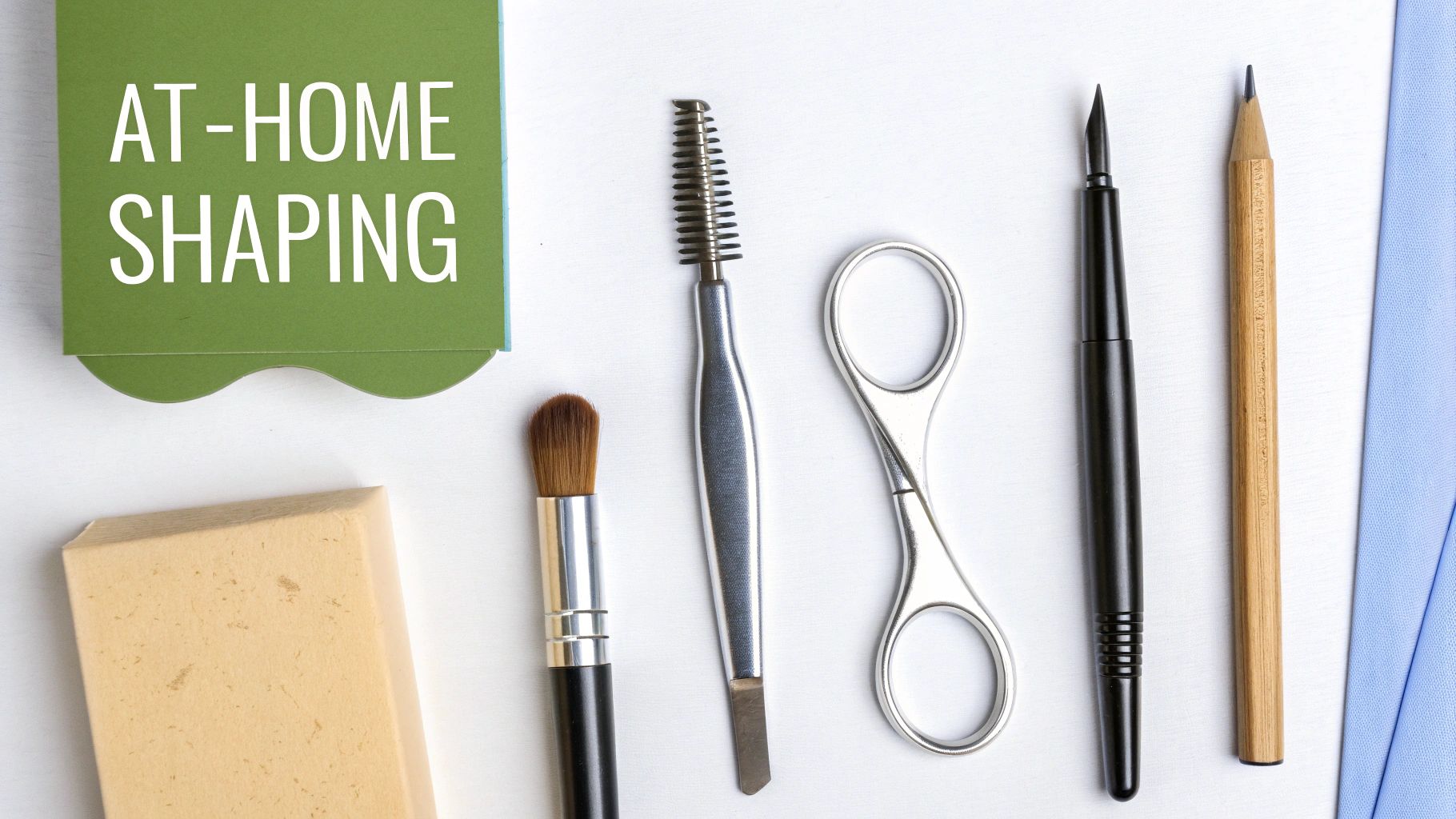 Flat lay of at-home eyebrow shaping tools including tweezers, scissors, brushes, and a card reading 'AT-HOME SHAPING'.