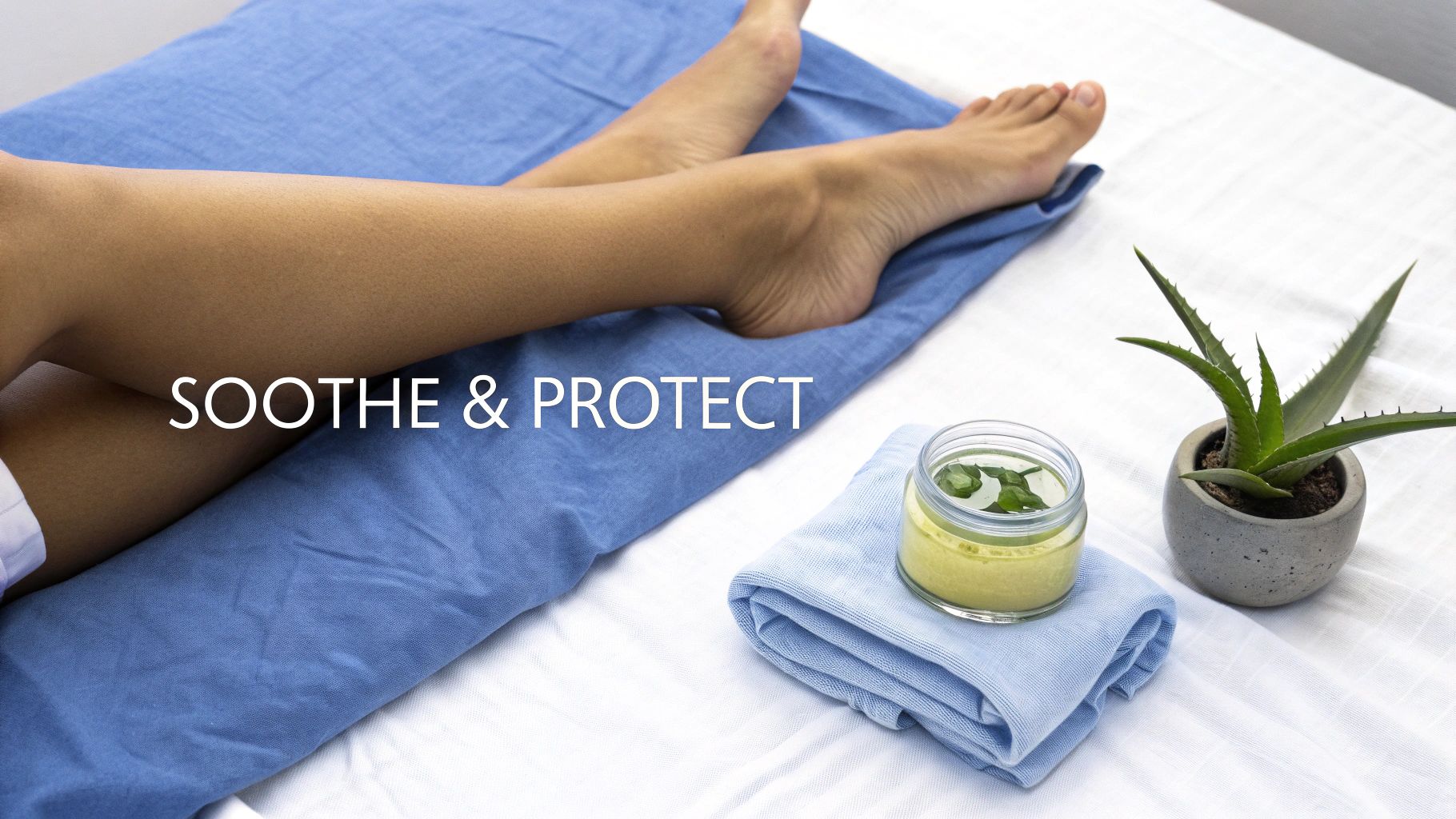 A woman with a towel wrapped around her hair applies a moisturizing cream to her smooth legs