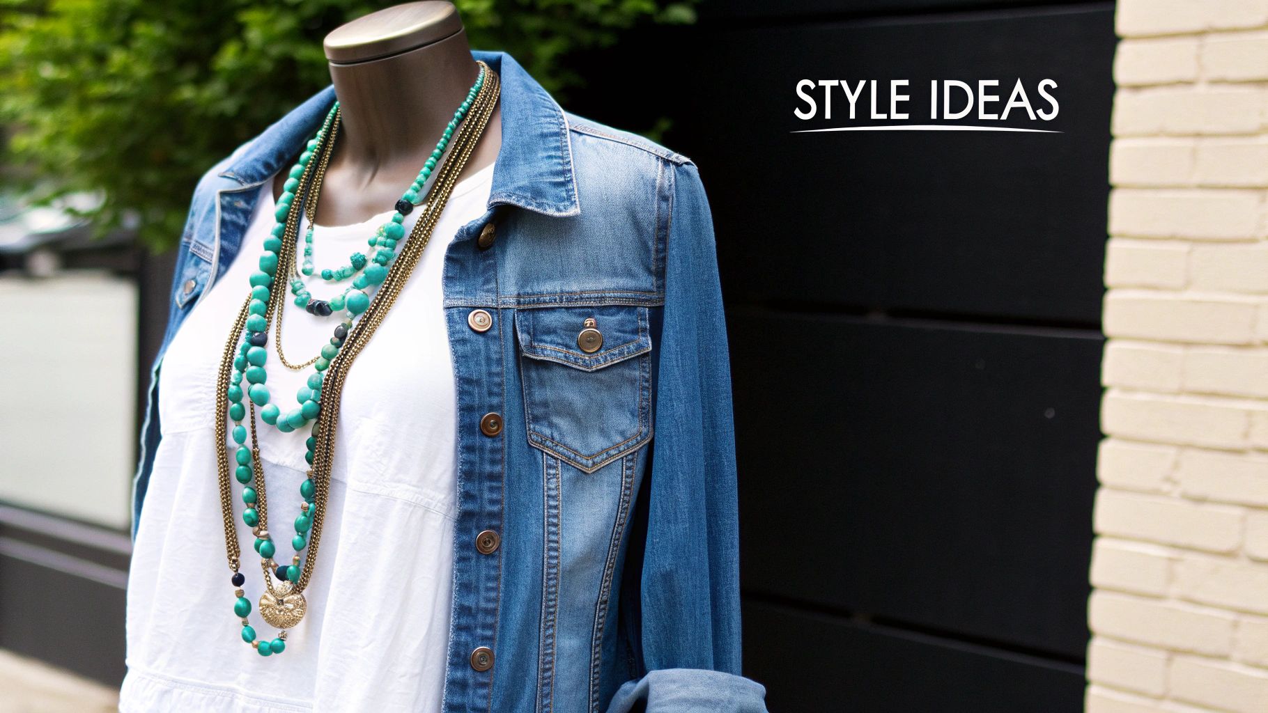 Mannequin wearing a denim jacket, white shirt, and layered turquoise and gold boho necklaces.