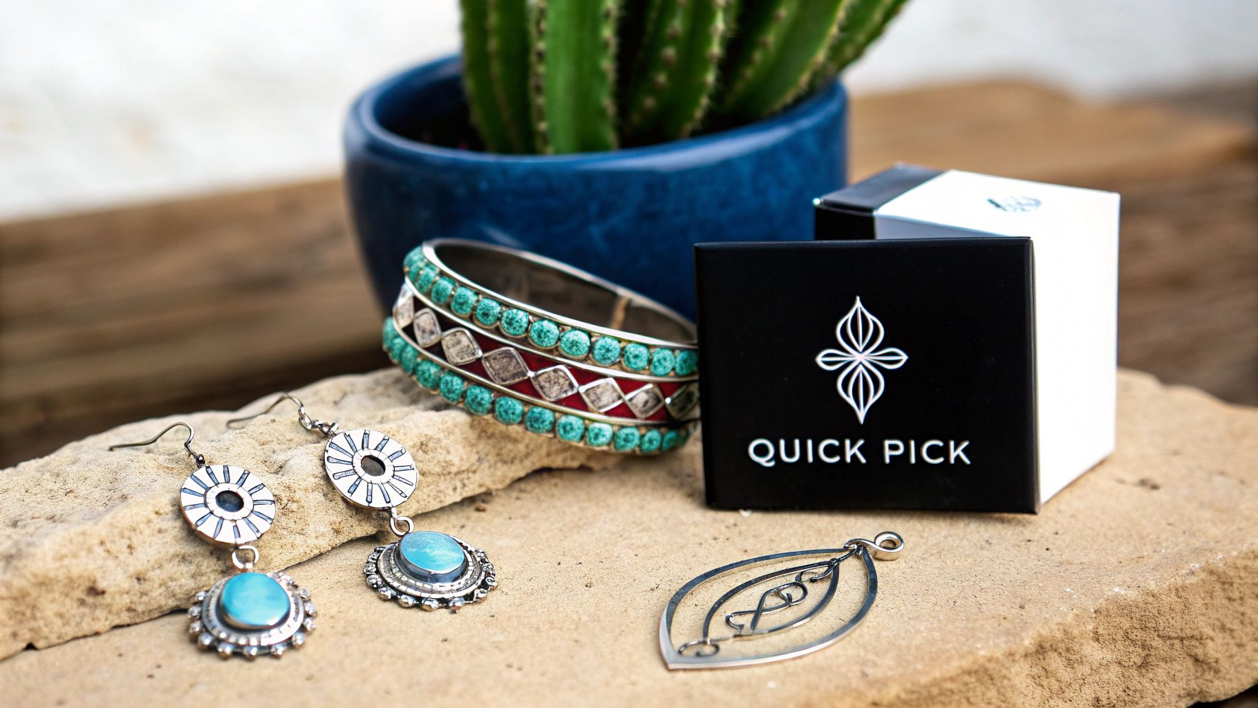 Bohemian turquoise earrings, bracelet, and silver pendant on a stone surface, beside a Quick Pick gift box.
