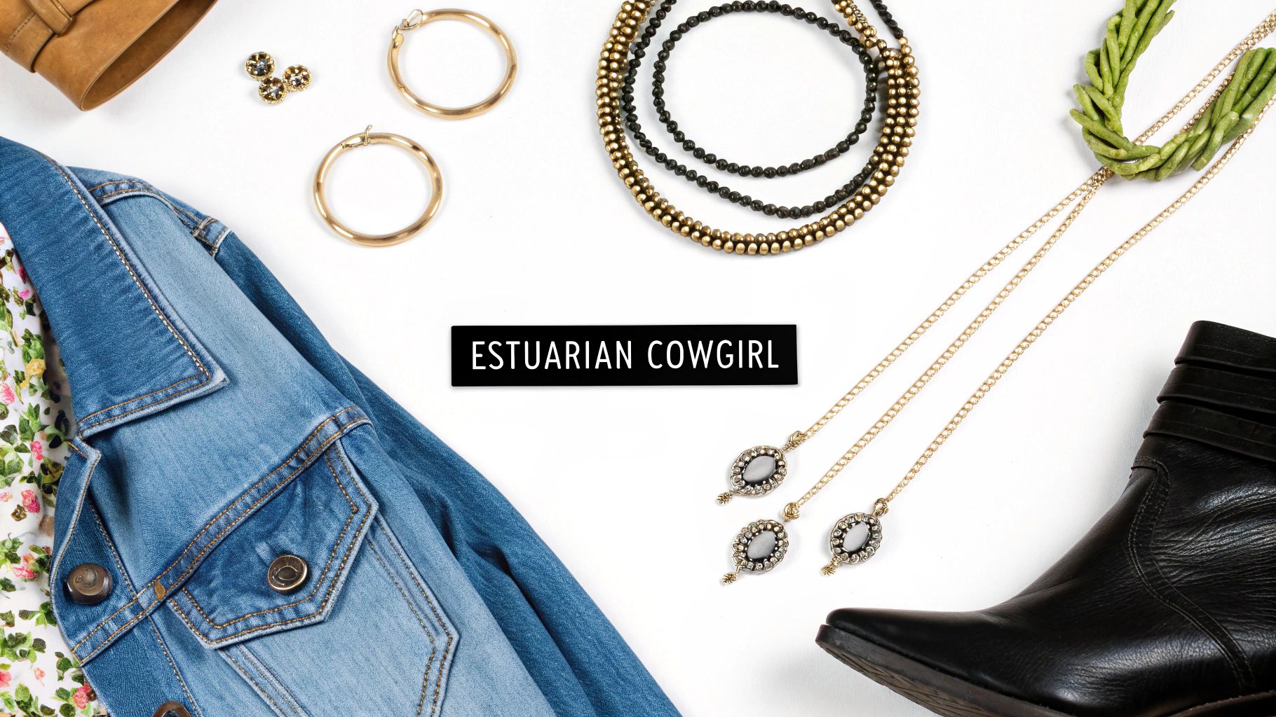 A woman wearing a layered boho jewelry look with a denim jacket and hat