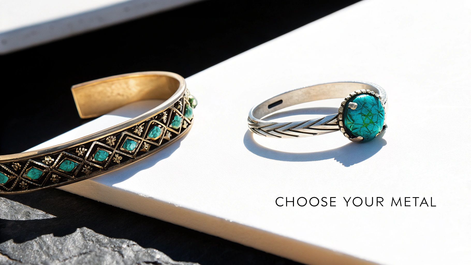 Two pieces of jewelry: a gold-toned cuff bracelet with turquoise stones and a silver ring with a blue-green stone, on a white surface.