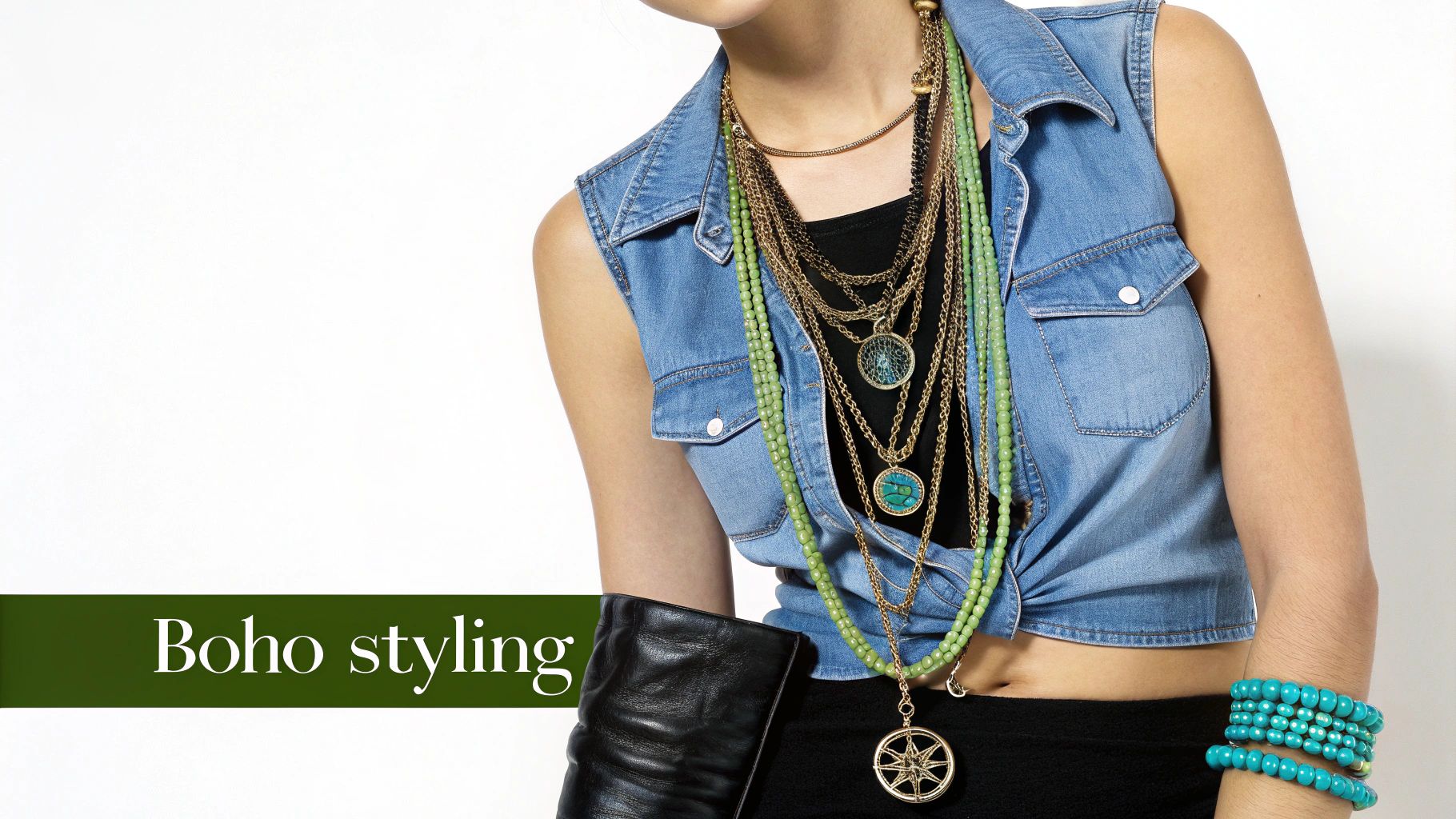 A woman wearing a blue denim vest and abundant layered bohemian jewelry with gold, green, and turquoise beads.