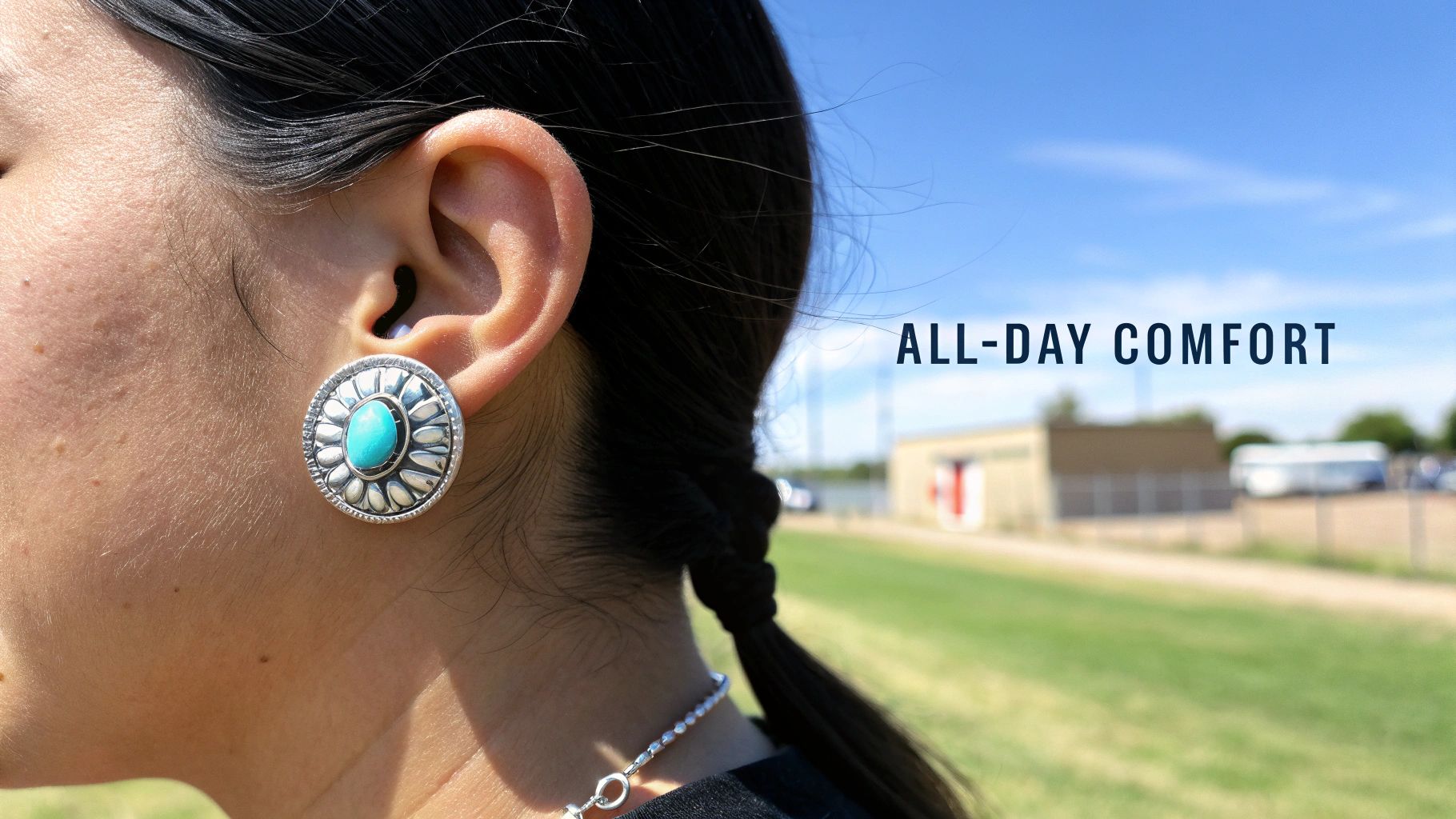 Close-up of an ear wearing a round sterling silver and turquoise earring, promoting all-day comfort.