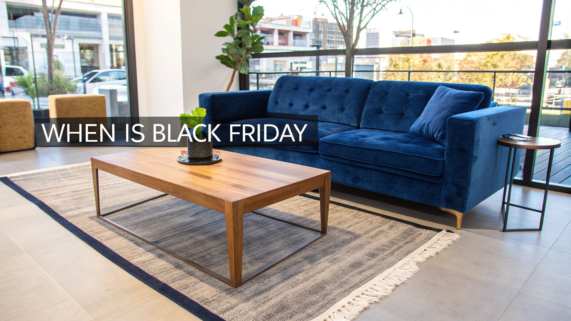 A modern living room featuring a blue velvet sofa, a wooden coffee table, and a patterned rug. Text overlay asks: 'WHEN IS BLACK FRIDAY'.