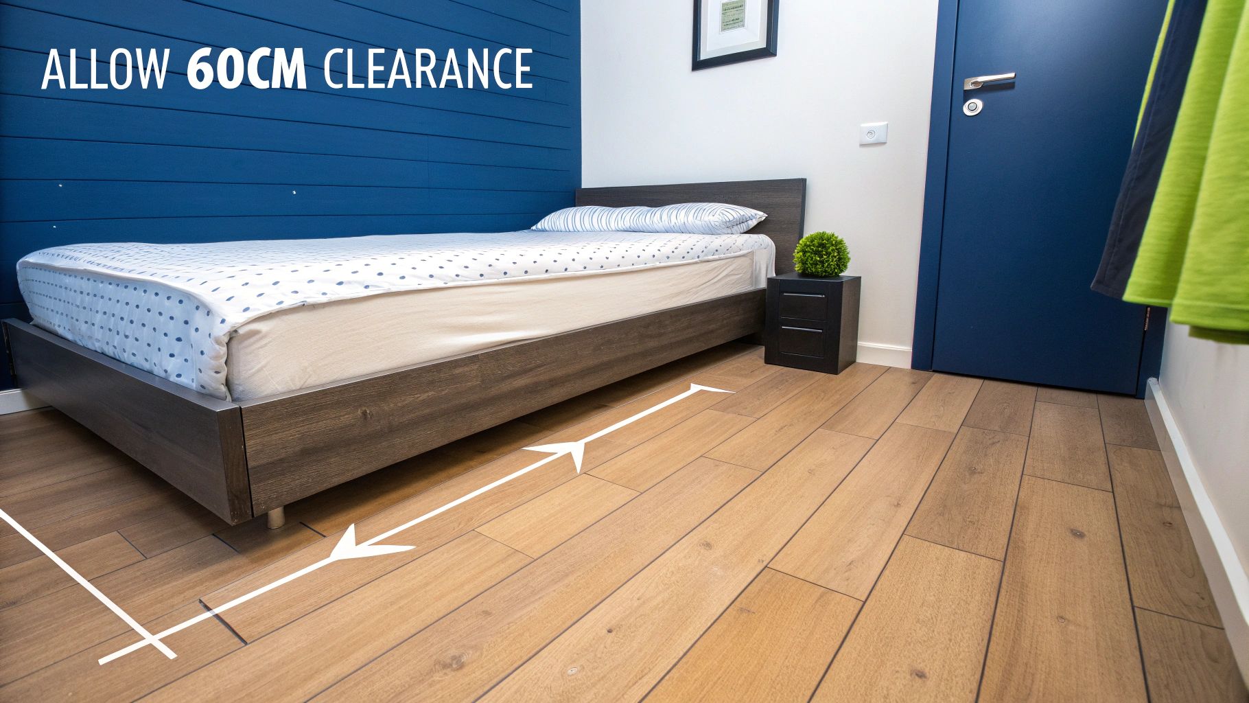 A bedroom showing a bed, nightstand, and blue wall with a white arrow indicating 60cm clearance.