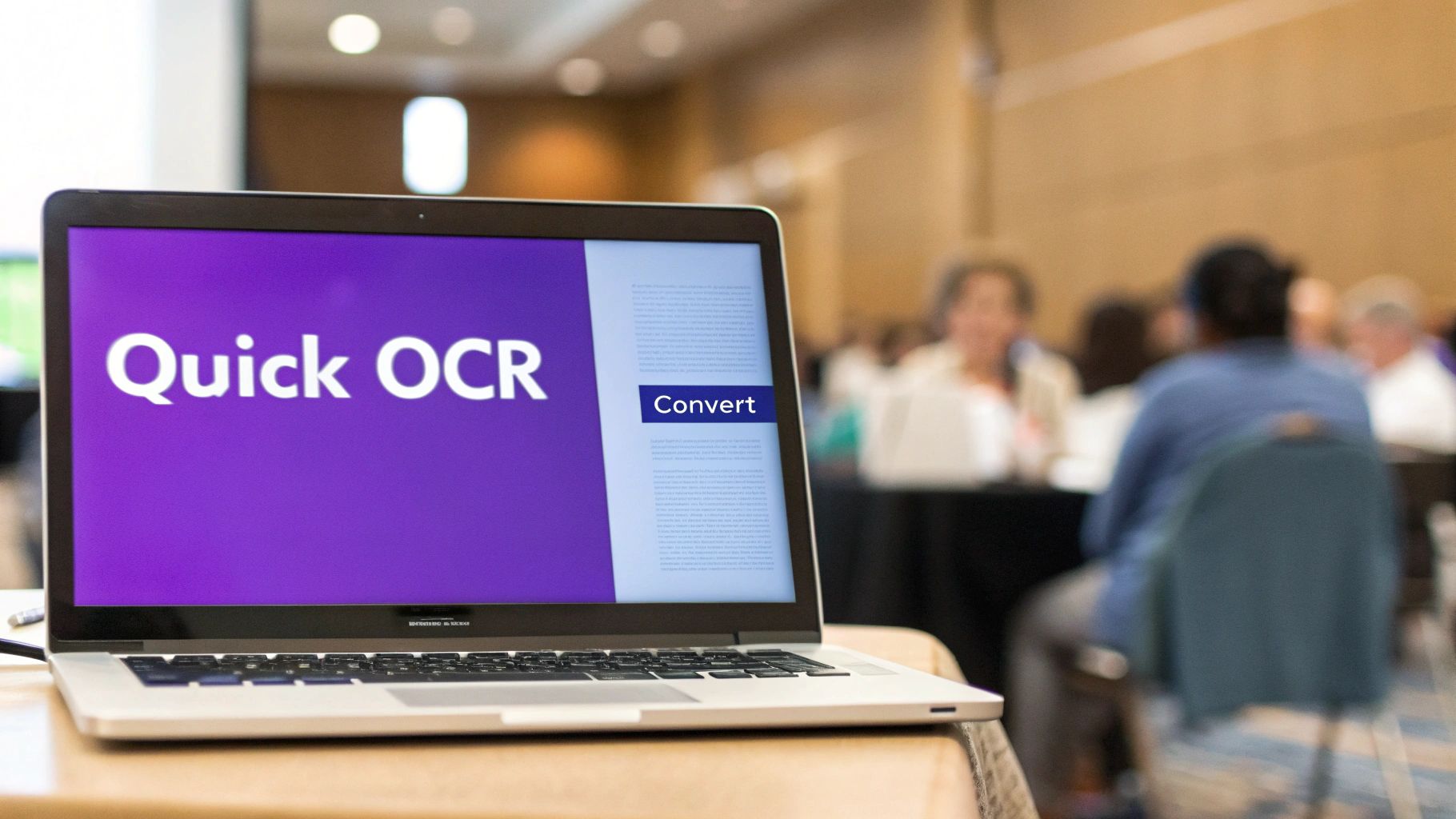 A person using a laptop to convert an image file into editable text.